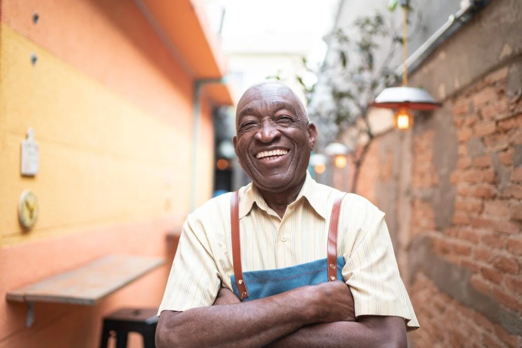 portrait-of-smiling-elderly-waiter-looking-at-camera-picture-id1164403642.jpg