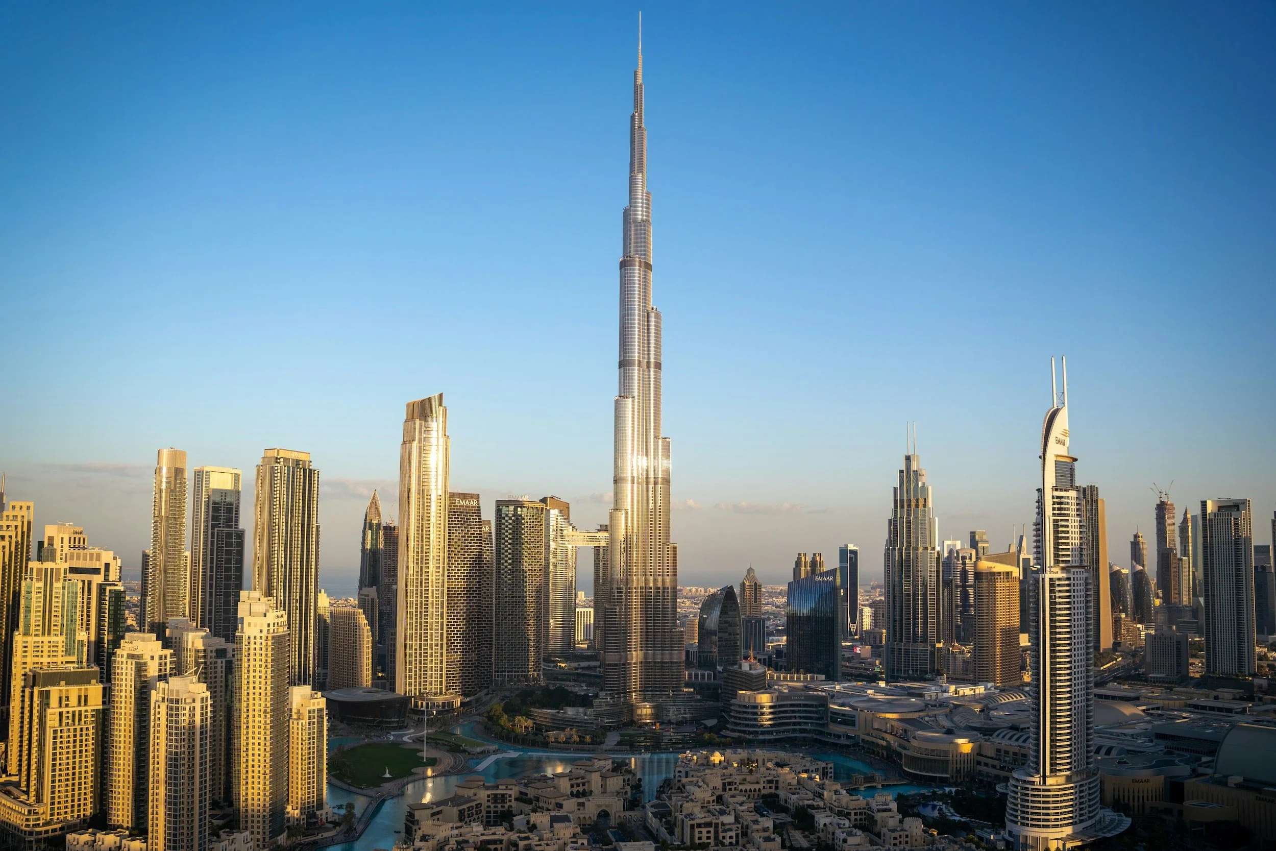Skyline view of Dubai with the Burj Khalifa, the world's tallest building, and other skyscrapers during daylight.