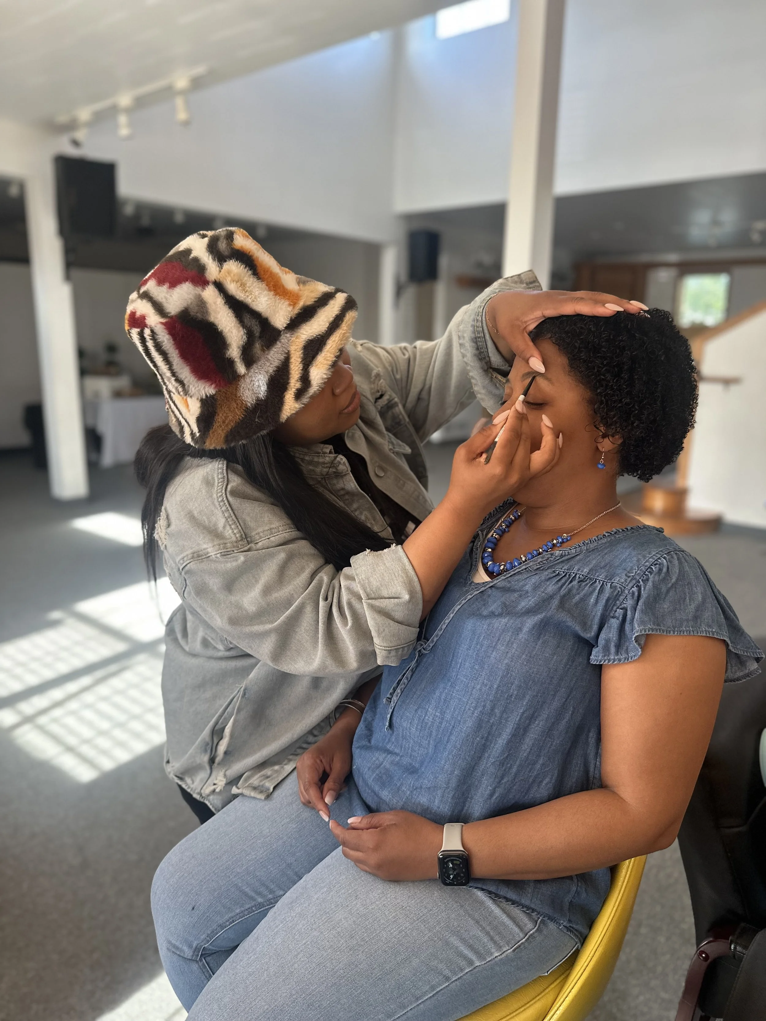 Woman getting her makeup done.