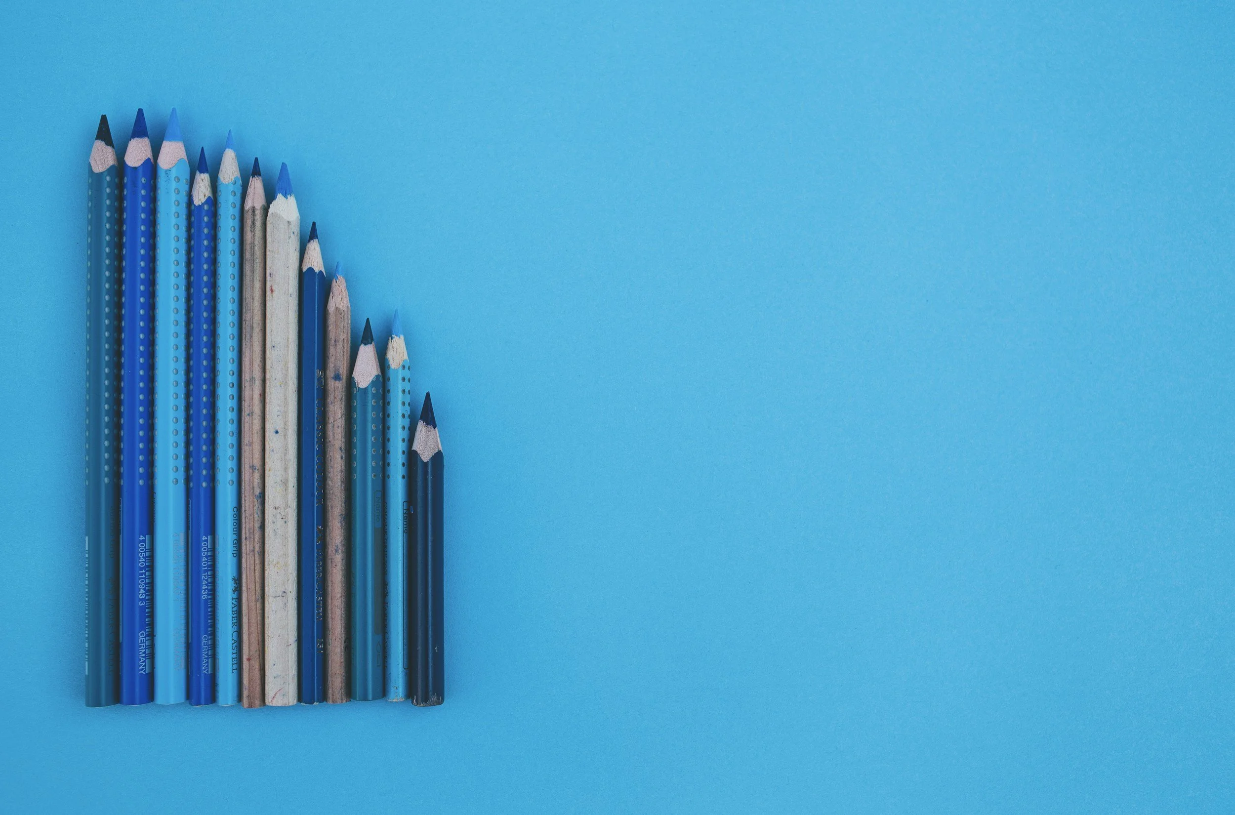 Image of pencils in a row, different shade of blue, on a blue background.  Symbolising all the various notes written here and there, no real systems in place, why you might need fractional operations support.