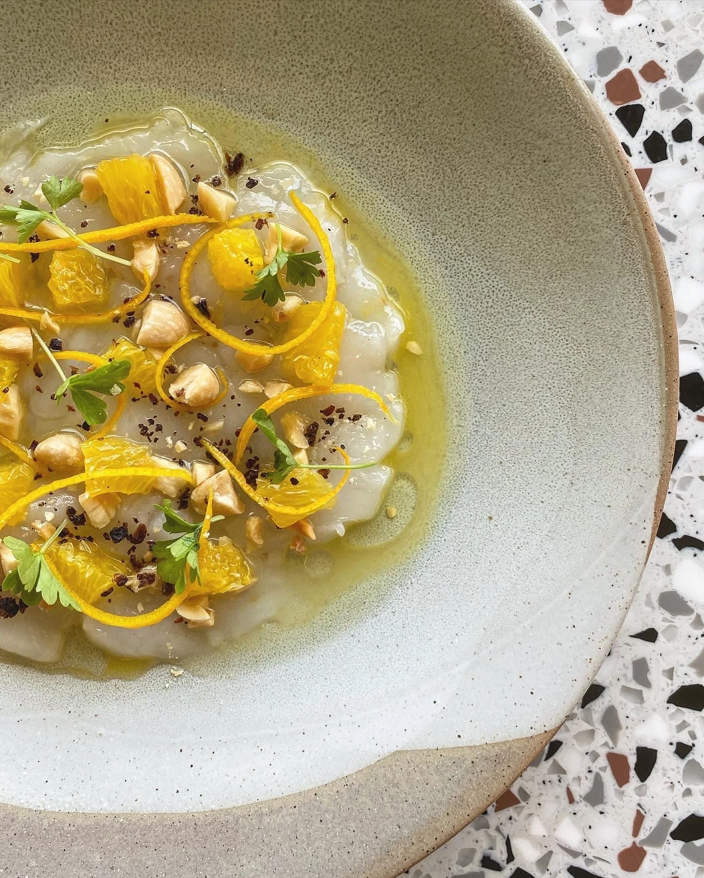 Shark Bay scallop crudo with juniper, orange, almonds and citrus dressin