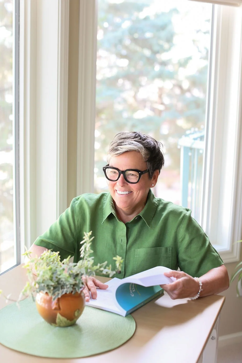 Michelle Hoff, author of Compassionate Decluttering, reading at a table