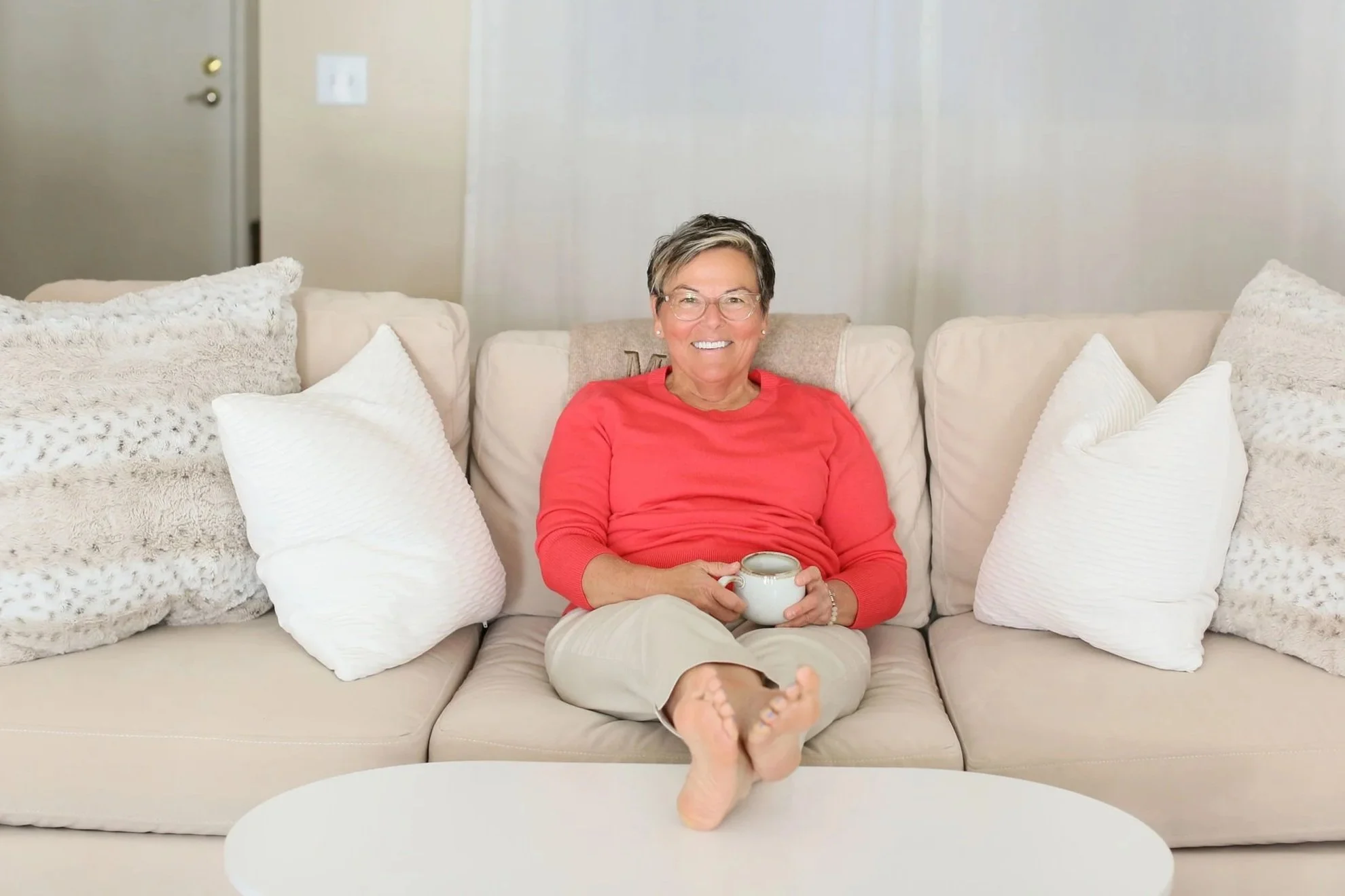 Michelle Hoff, compassionate decluttering coach, sitting in a calm home