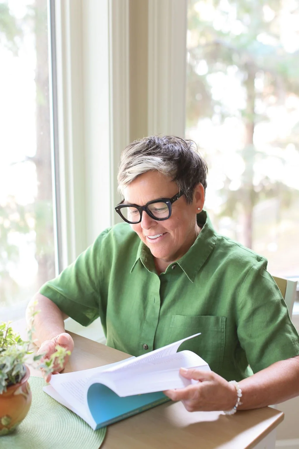 The founder reading a book at home, reflecting the thoughtful mindset behind Compassionate Decluttering.