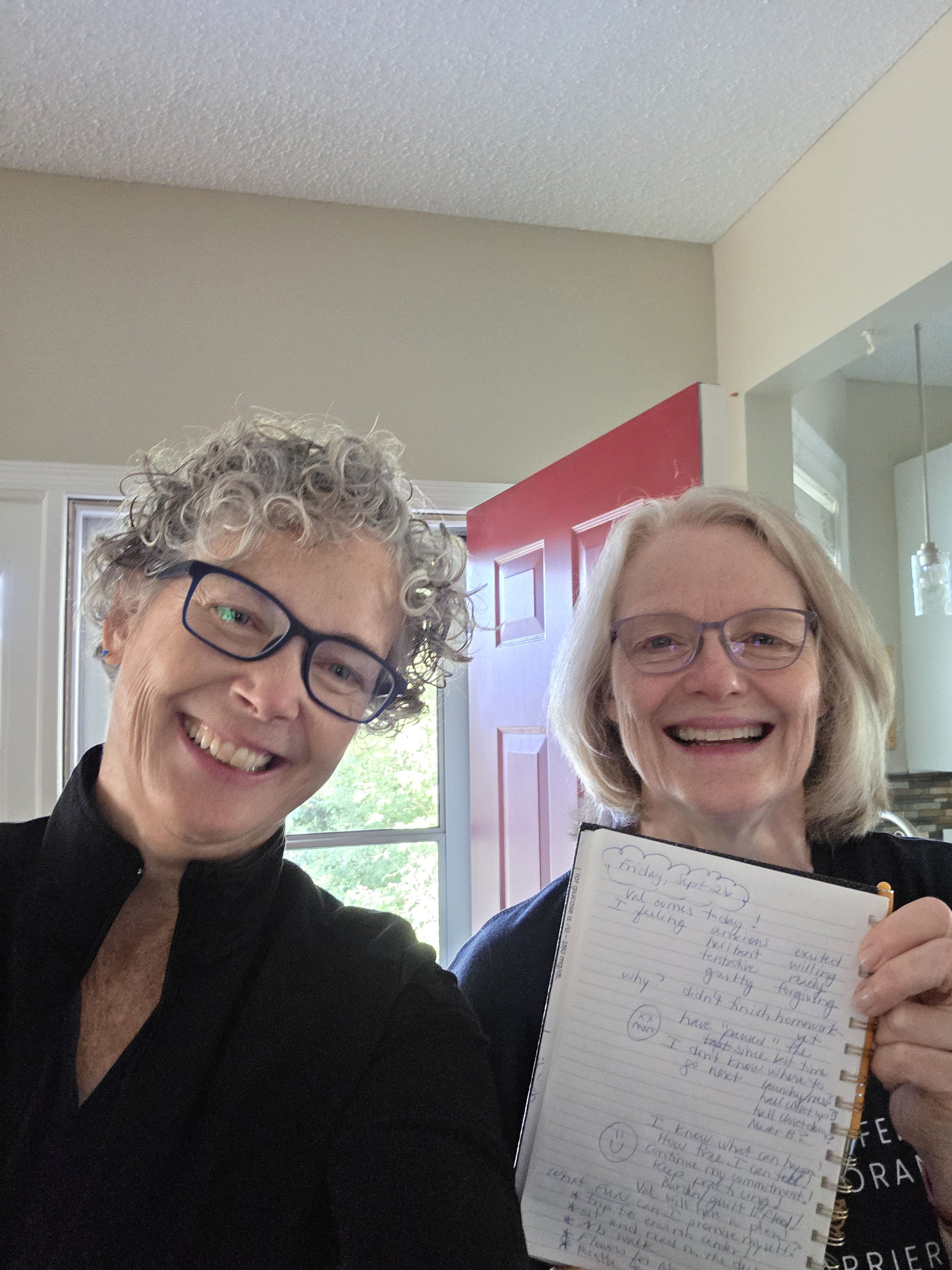 Clients during a decluttering and organizing session, holding handwritten notes