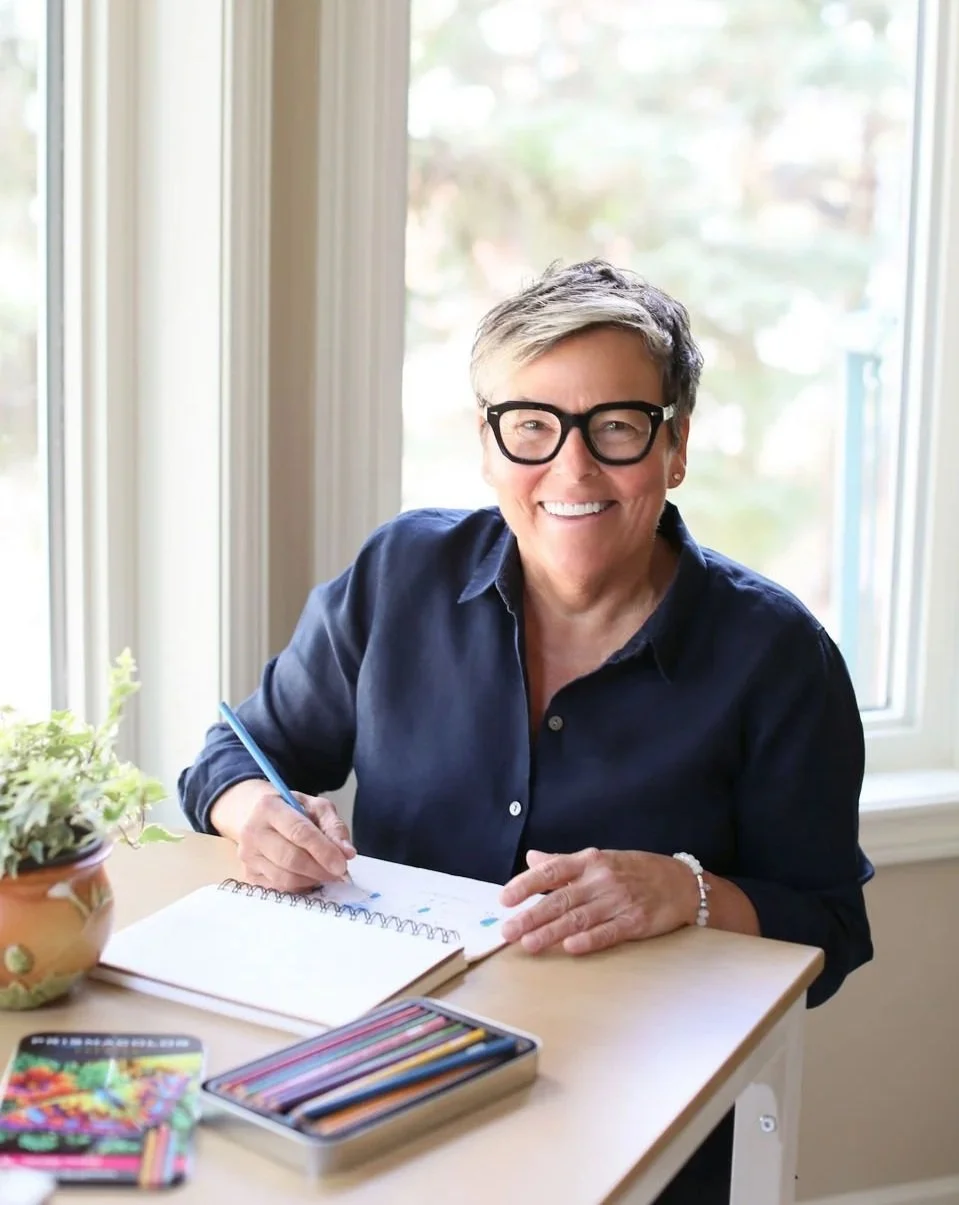 Michelle, professional decluttering and organizing consultant, working at a table with notes and colored pencils