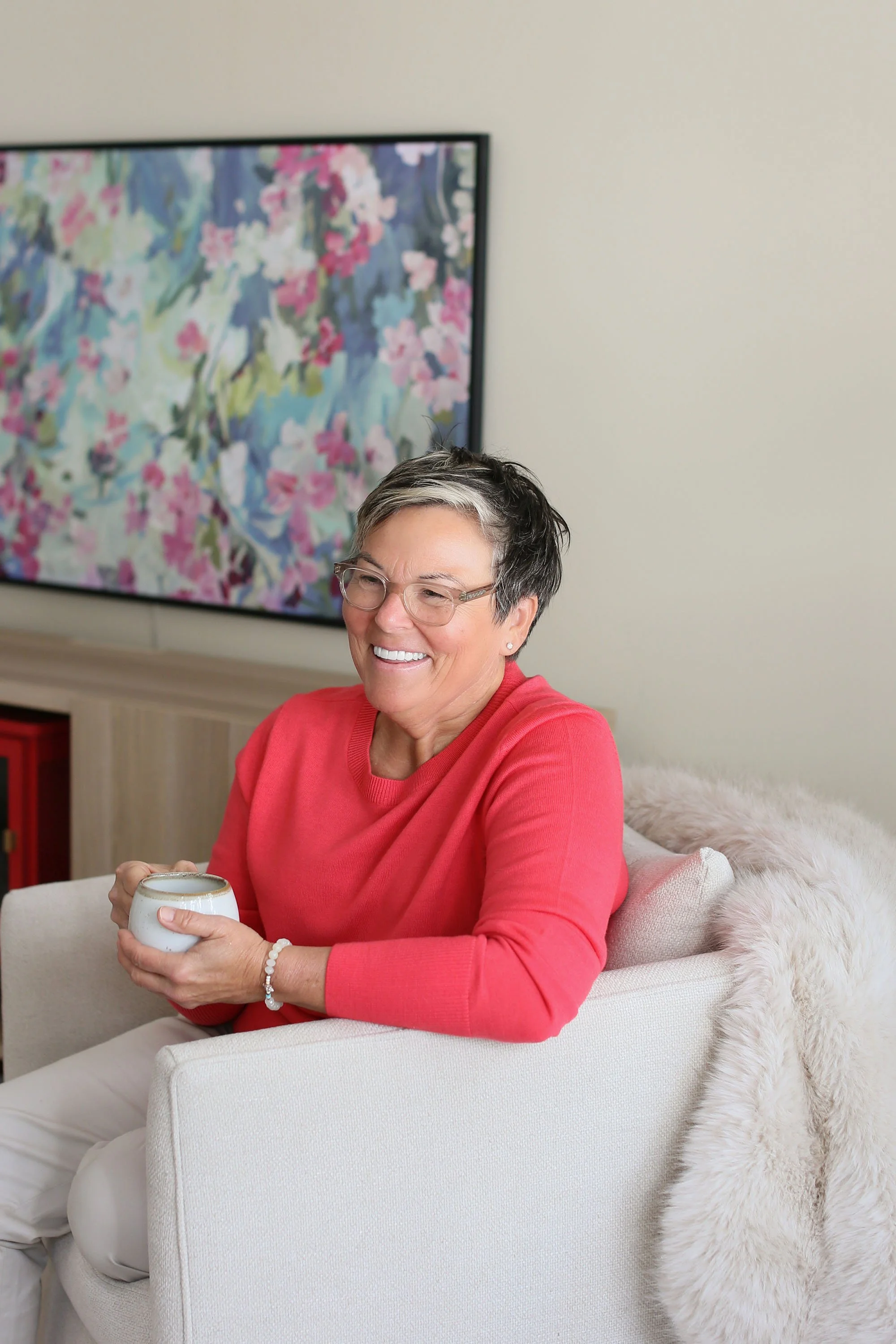 Michelle Hoff, compassionate decluttering coach, sitting in a calm home setting