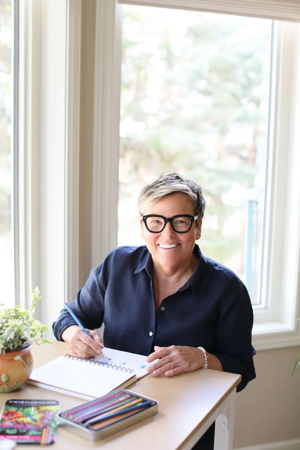 Michelle Hoff, decluttering coach for women, writing at a table