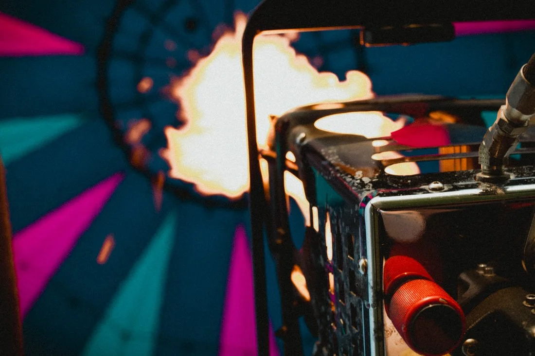 Close-up of a fireworks launcher with a bright explosion in the background.