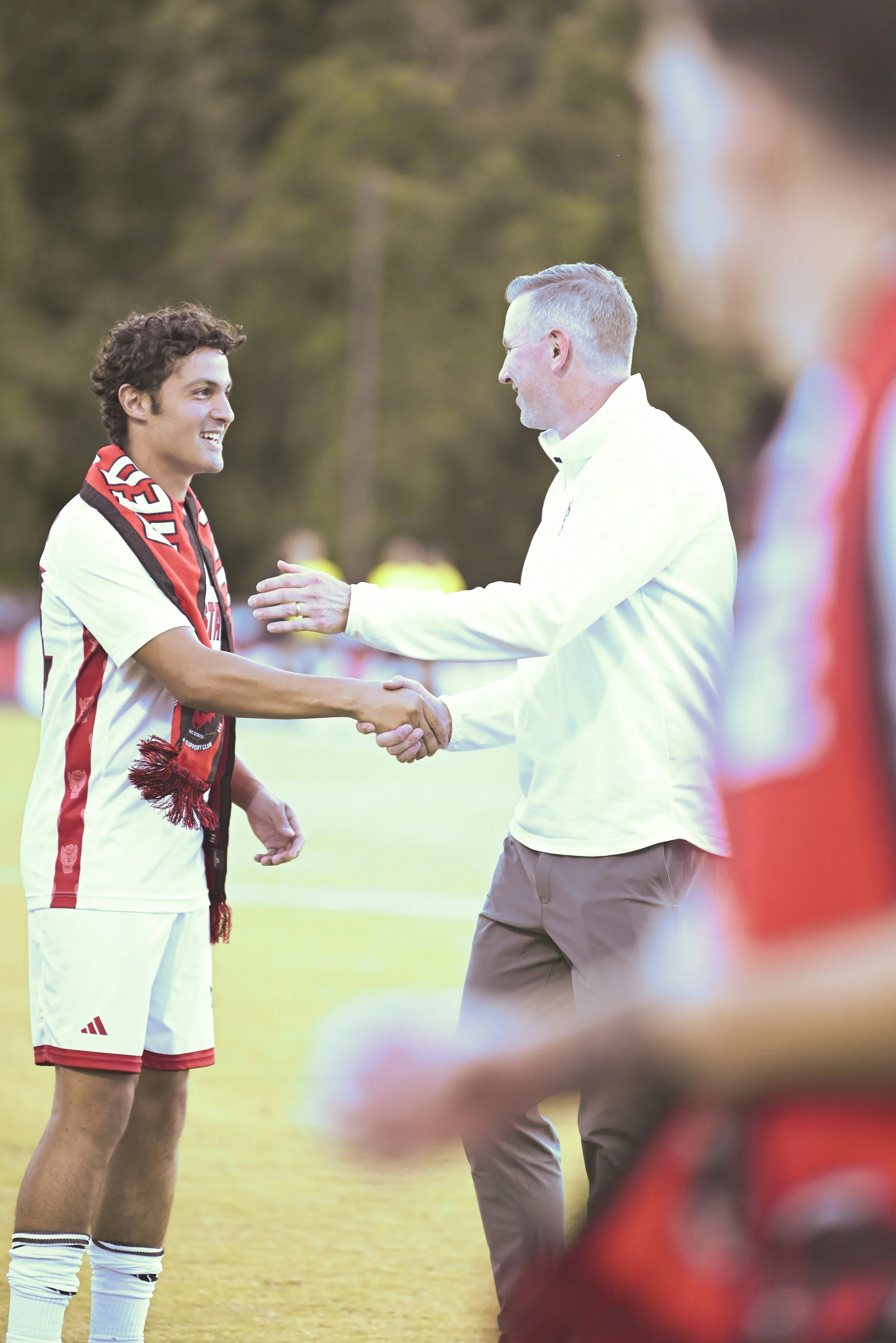 MSOCvsSMU_Fam and Hubbard Hand shake_NS.jpg