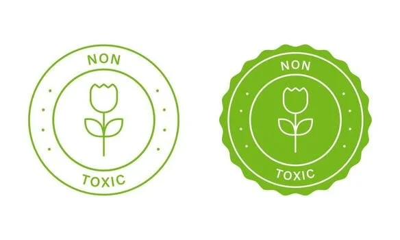 Two green eco-friendly certification seals, each with a flower inside, the left one with a plain circle and the right one with a scalloped edge, indicating "Non Toxic."