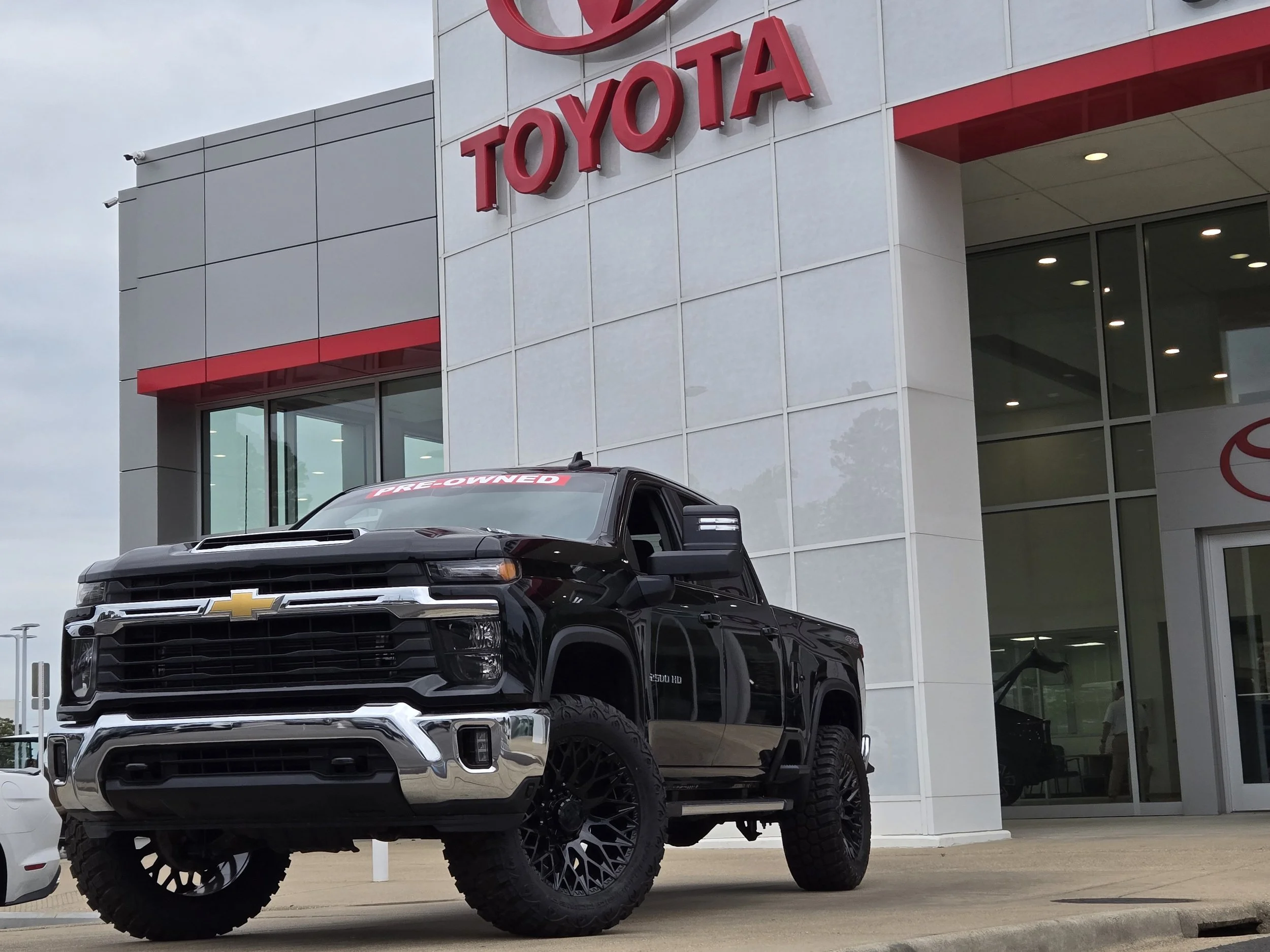 cinematic automotive photography of Chevrolet vehicle outside Toyota dealership in Hot Springs Arkansas