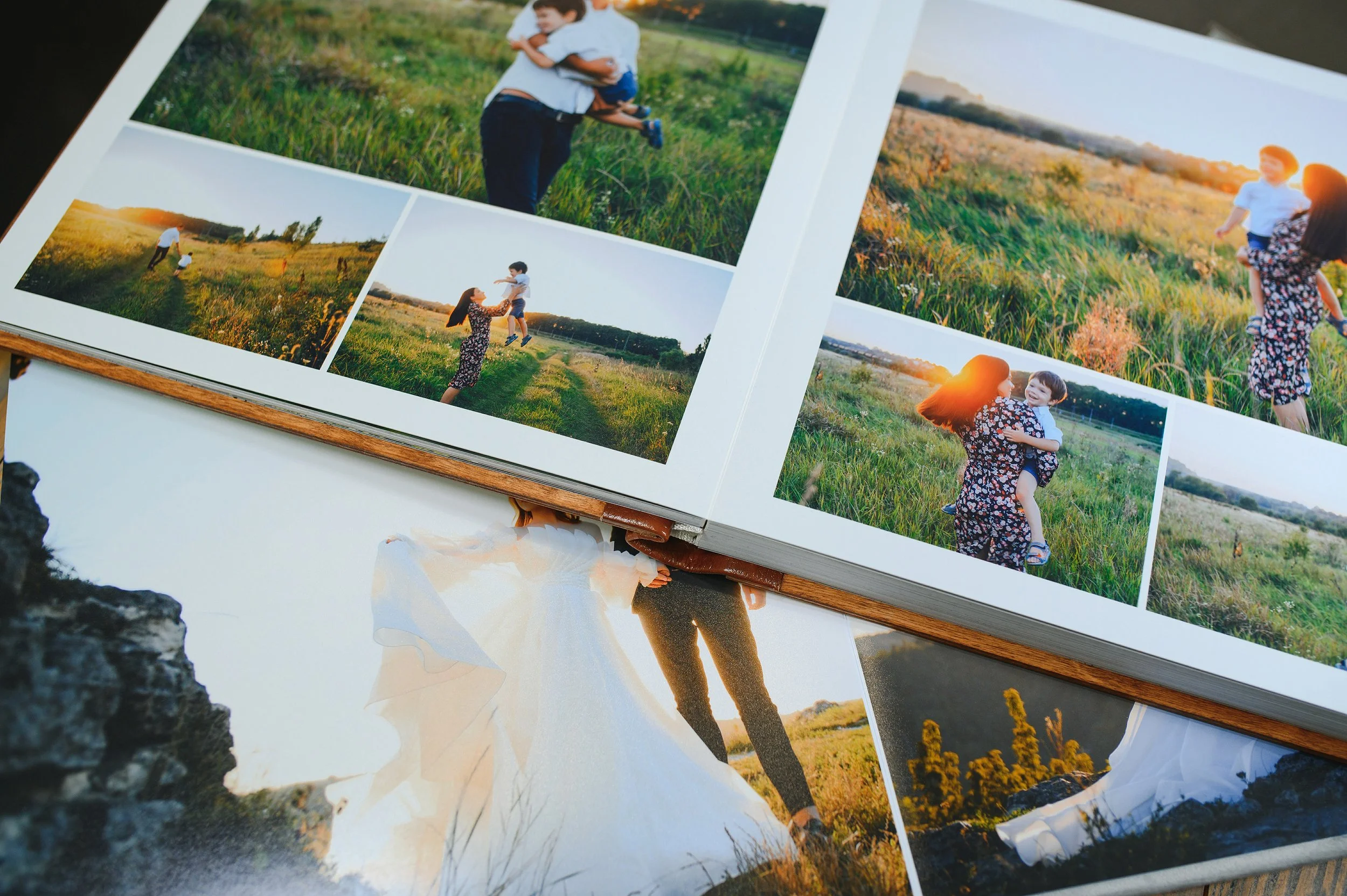 Photobook showing pictures of a woman and a young boy playing in a field during sunset, with some photos of them running and jumping together.