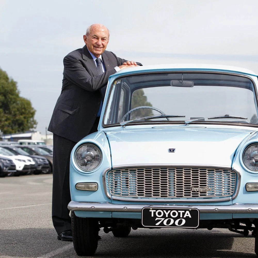 Stan Perron standing with a Toyota 700.