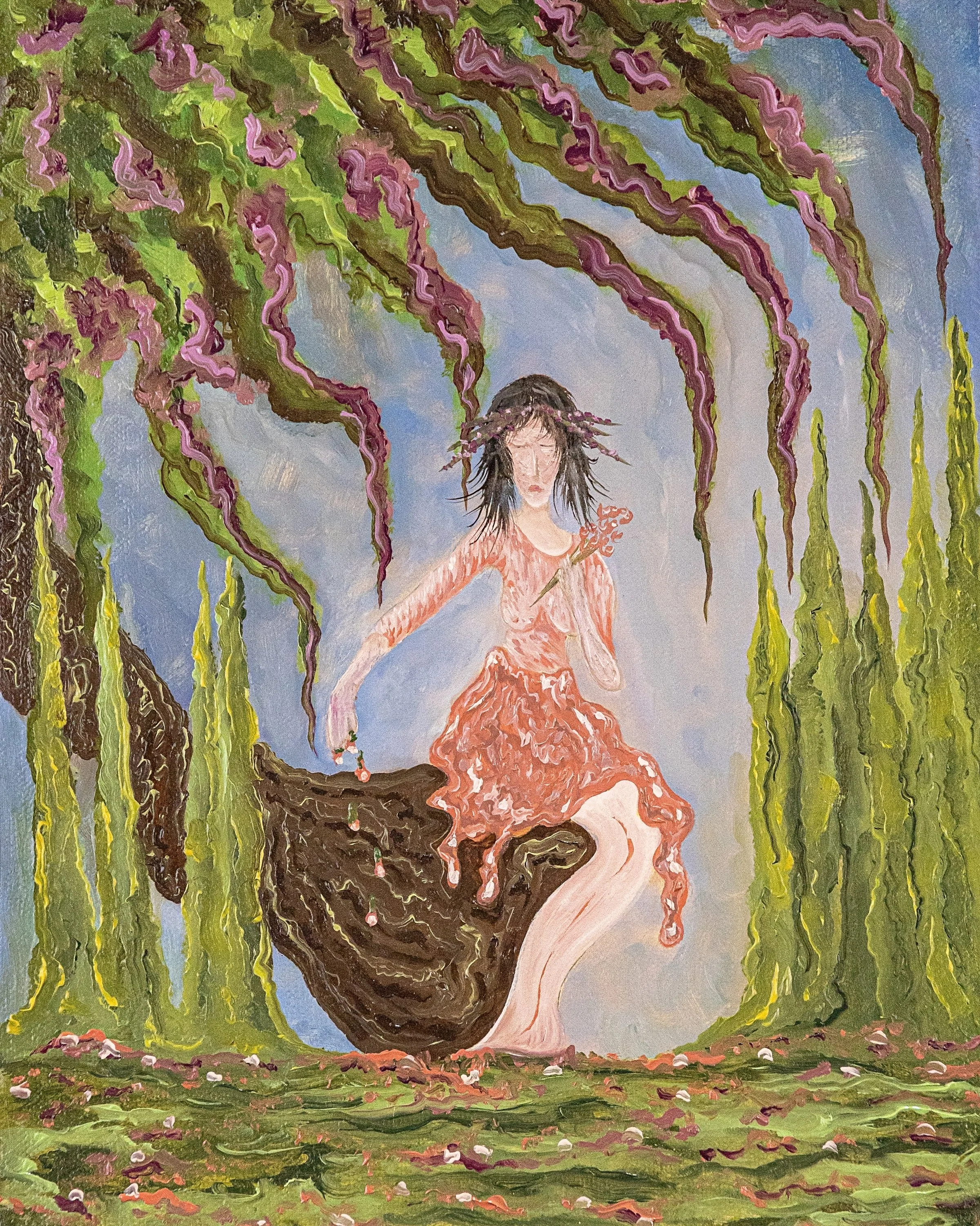 A surreal painting depicts a woman with black hair, wearing a pink dress, sitting on a tree branch holding a small branch with blossoms. Surrounding her are hanging green and purple vines and tall green plants. The background features a soft blue sky and the ground is covered with rocks and fallen flowers.
