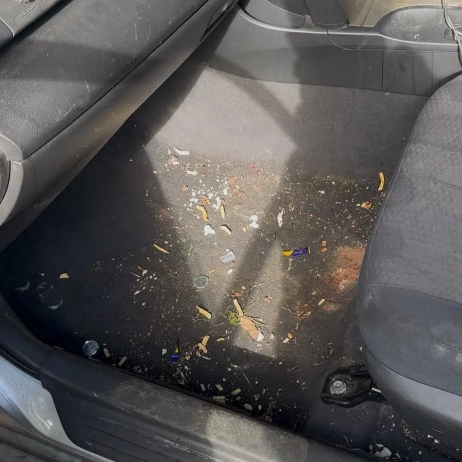 Heavily soiled vehicle interior with dirt and debris before professional deep cleaning and interior detailing