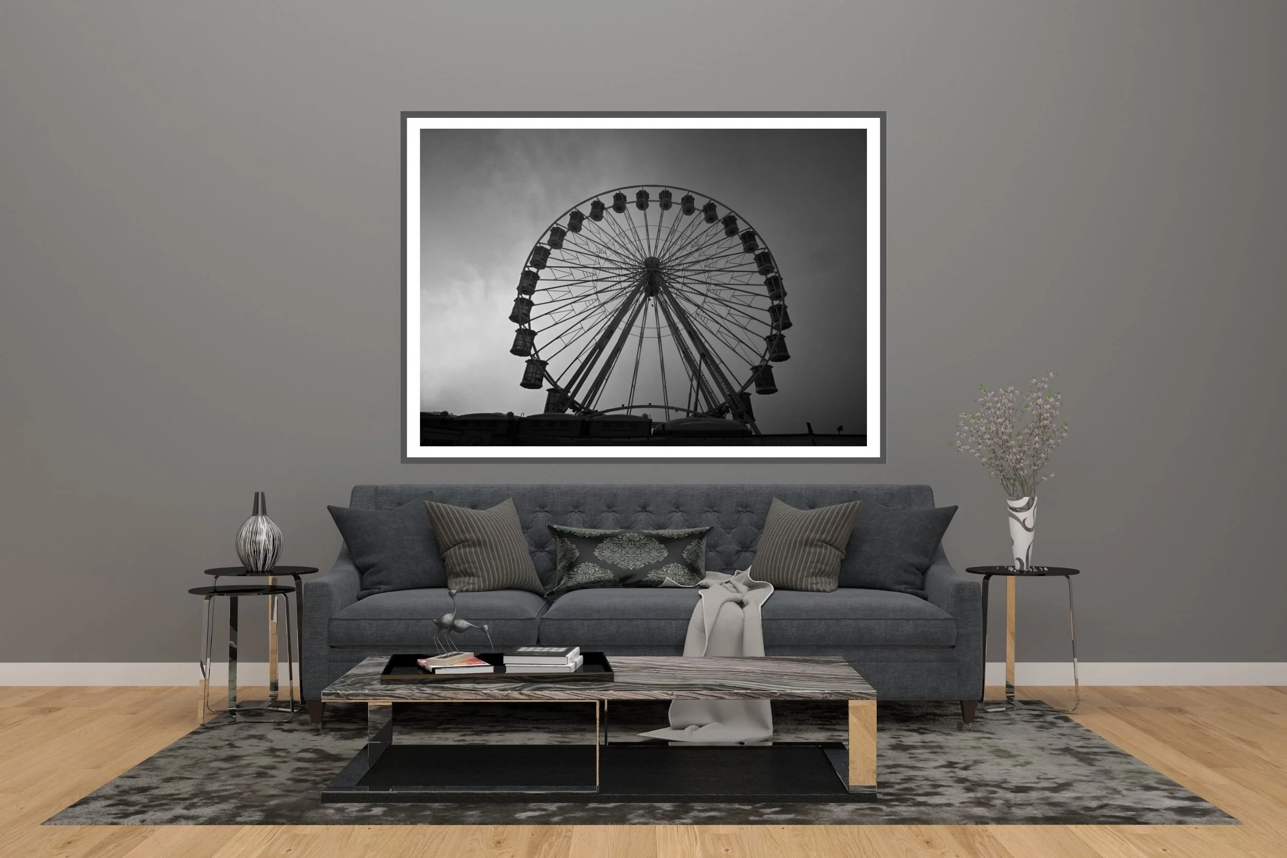 A striking black and white photograph of a carnival ferris wheel set against a foggy and cloudy background