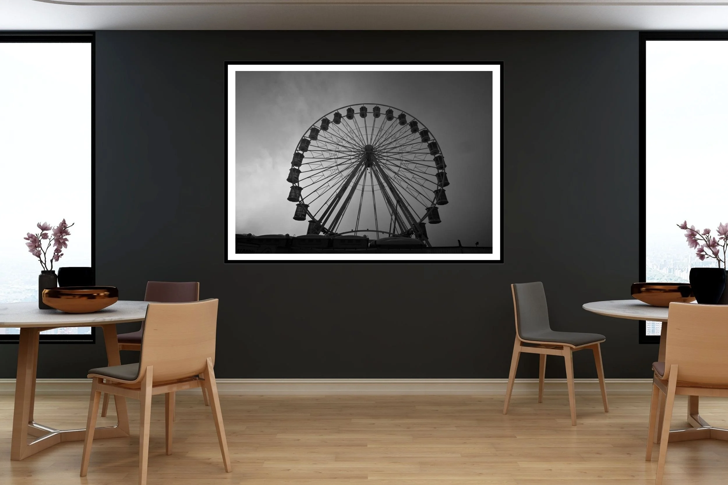 A striking black and white photograph of a carnival ferris wheel set against a foggy and cloudy background