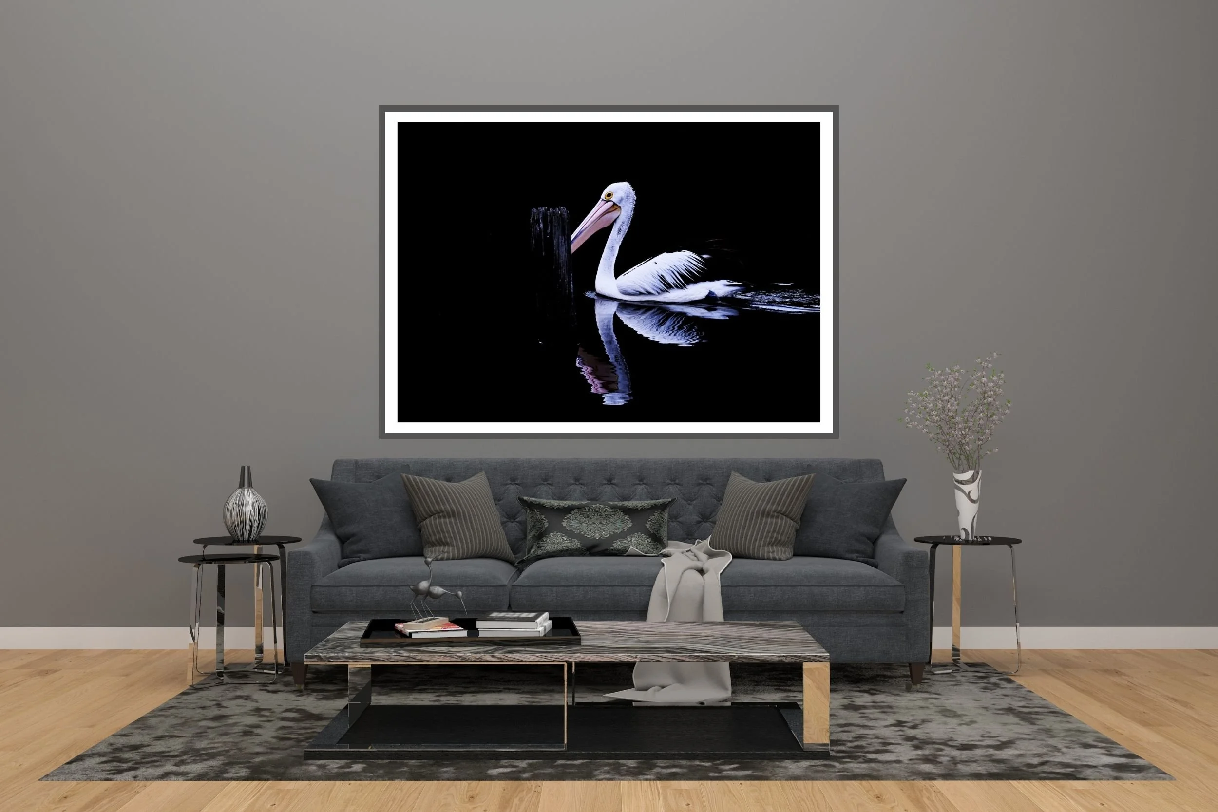 A striking minimalist photograph of a black and white Pelican set against a deep black background