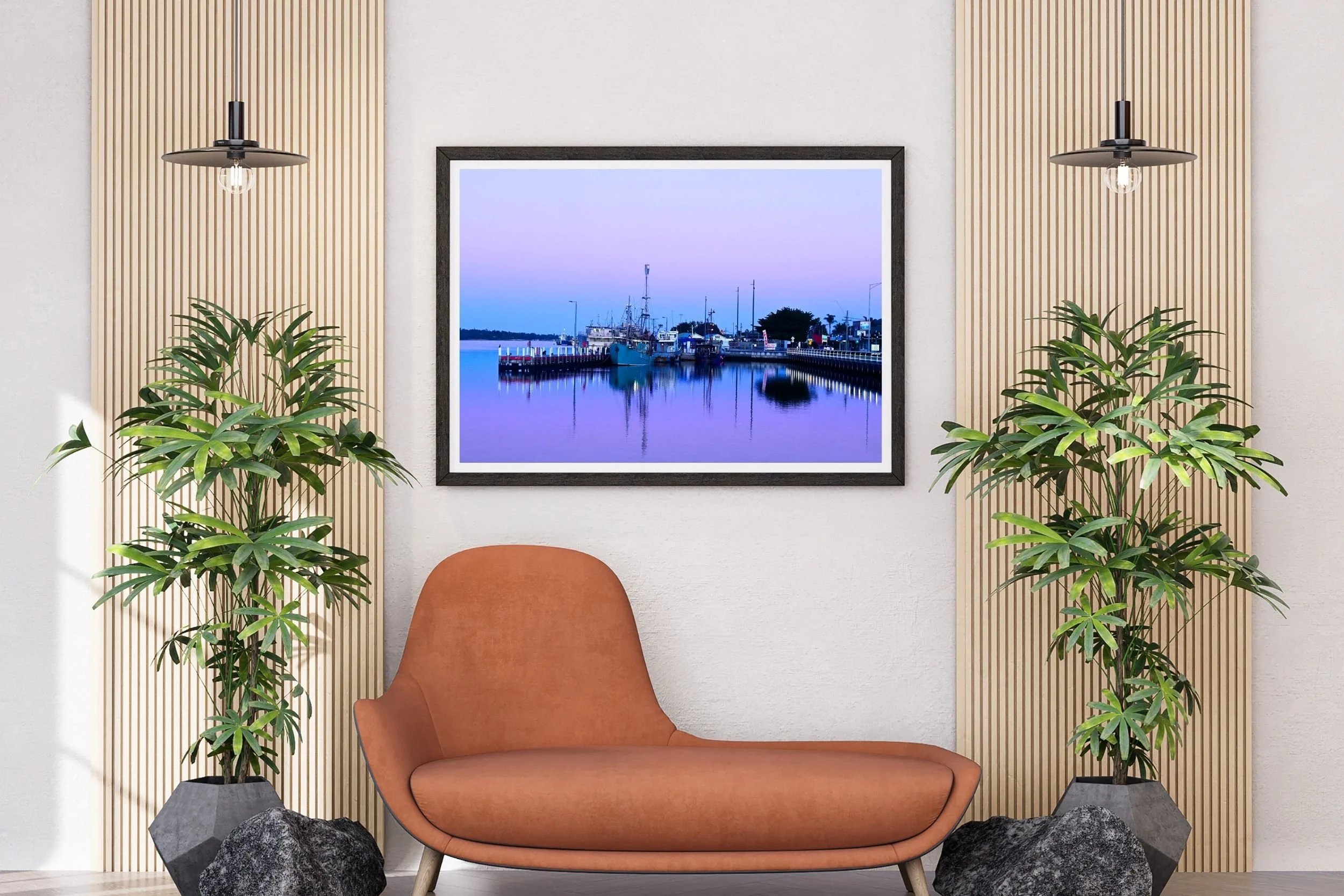 A serene blue hour harbour scene featuring fishing boats and mirror-like reflections on calm water in Lakes Entrance Australia.
