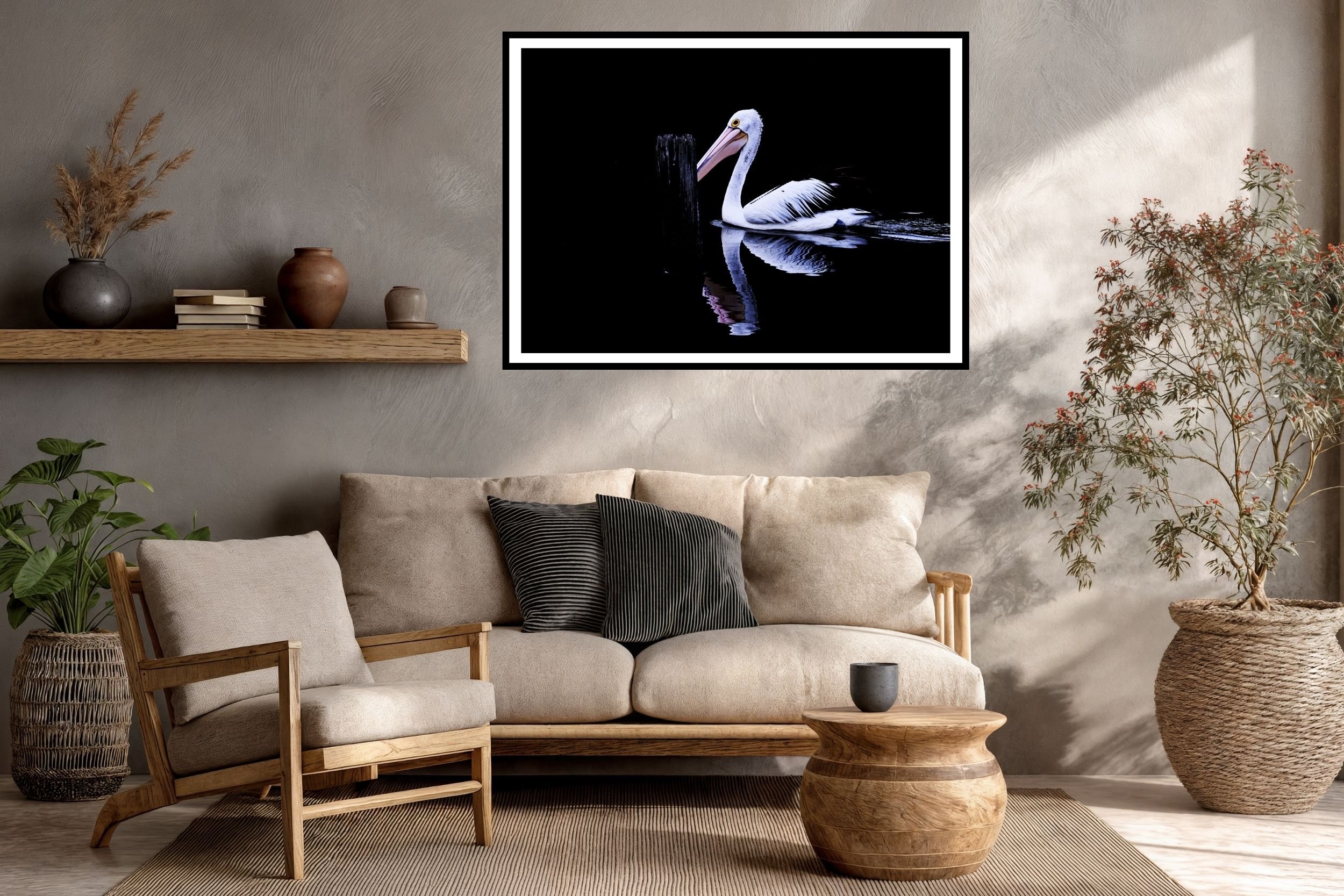 A striking minimalist photograph of a black and white Pelican set against a deep black background