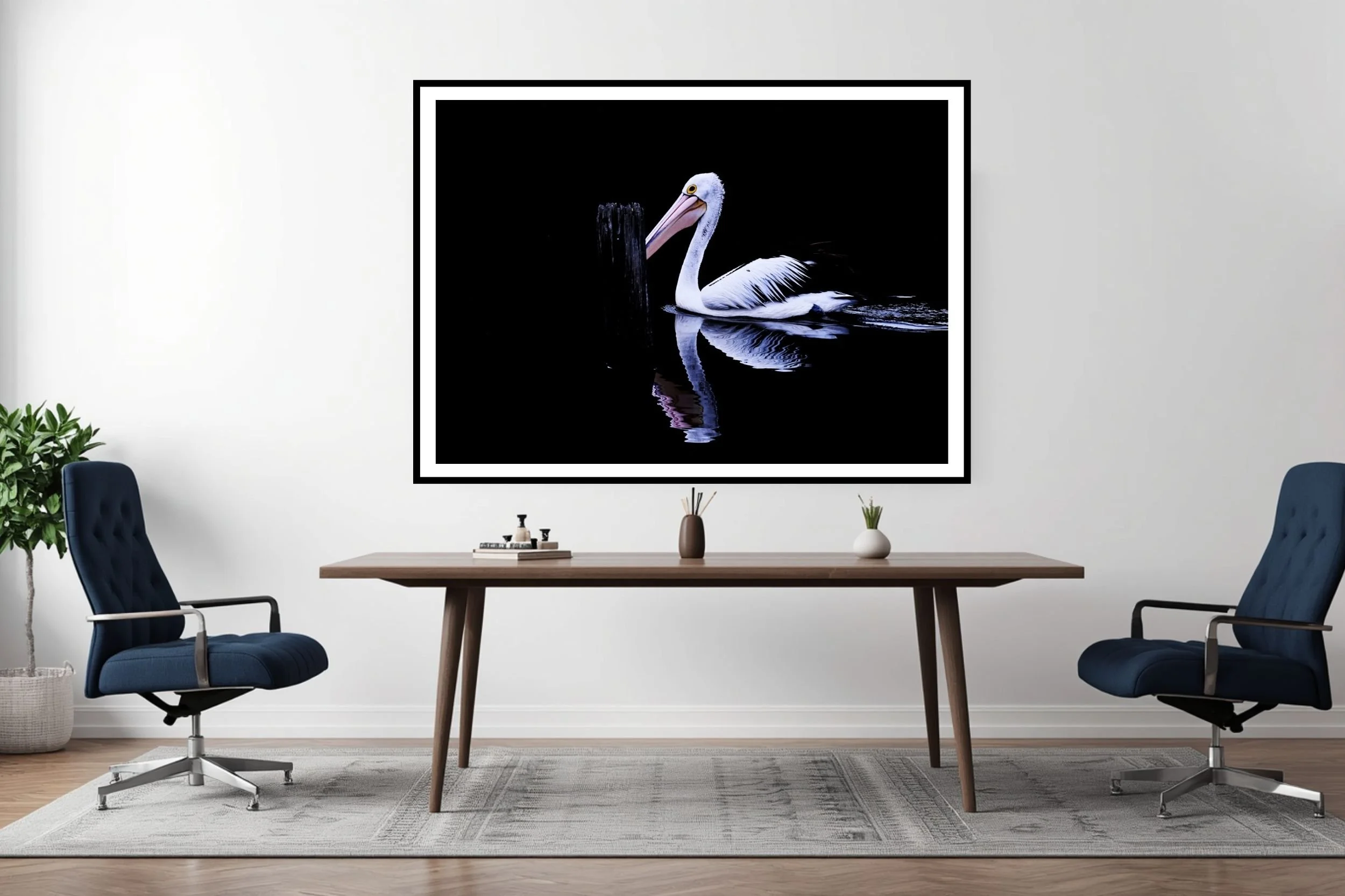 A striking minimalist photograph of a black and white Pelican set against a deep black background