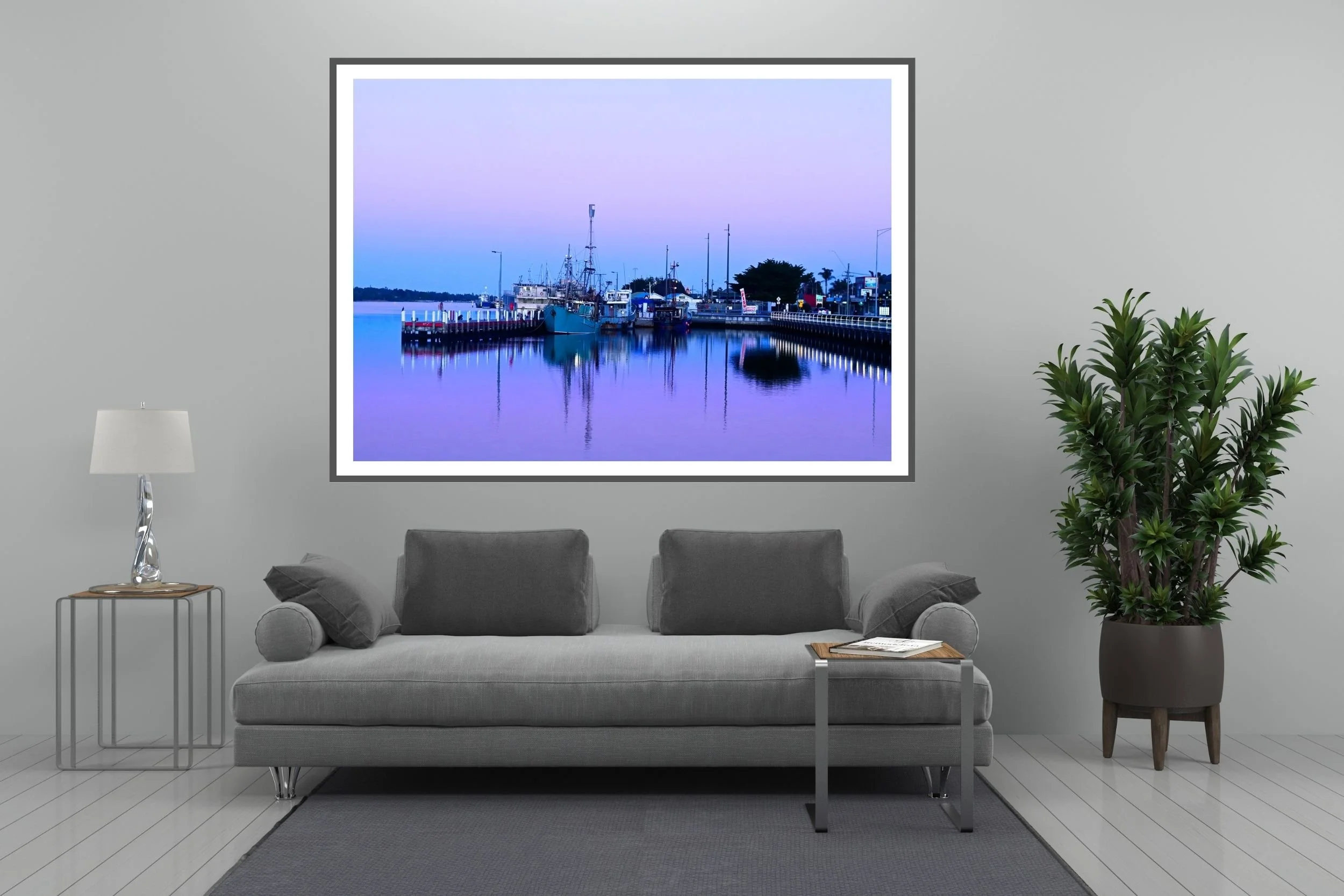A serene blue hour harbour scene featuring fishing boats and mirror-like reflections on calm water in Lakes Entrance Australia.
