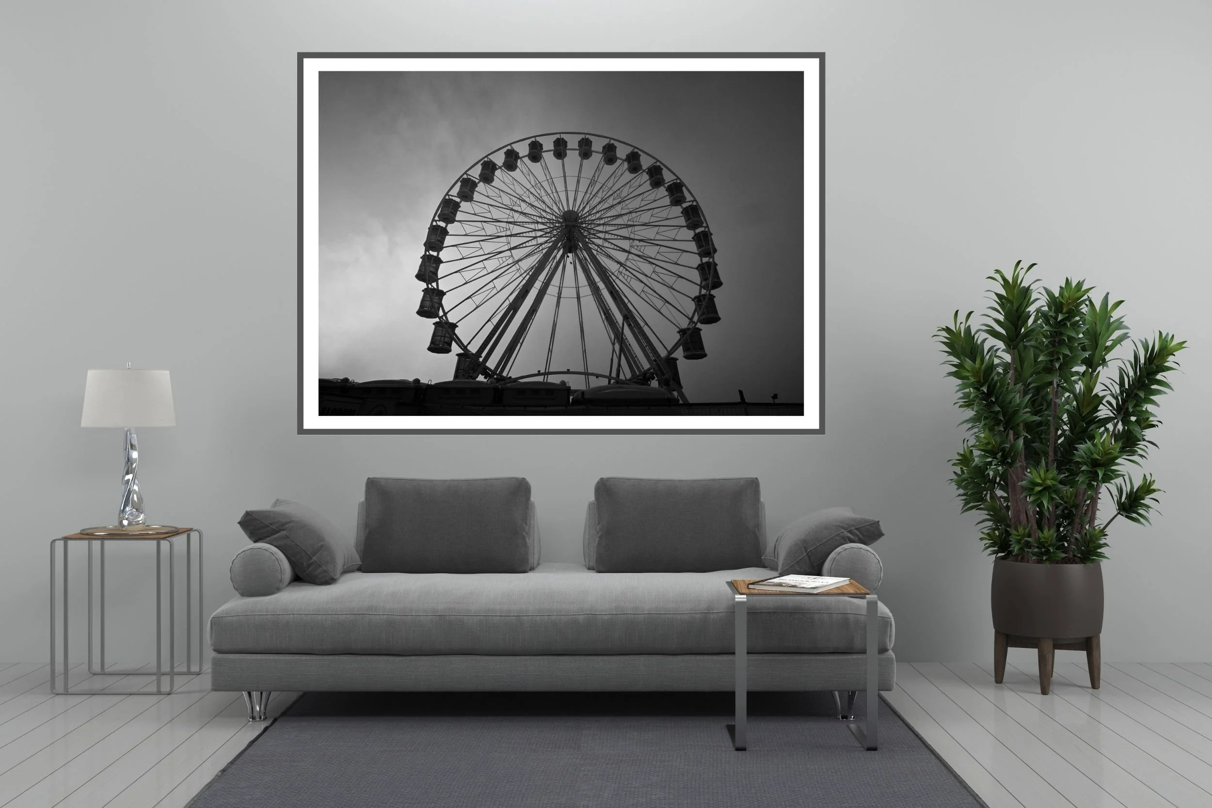 A striking black and white photograph of a carnival ferris wheel set against a foggy and cloudy background