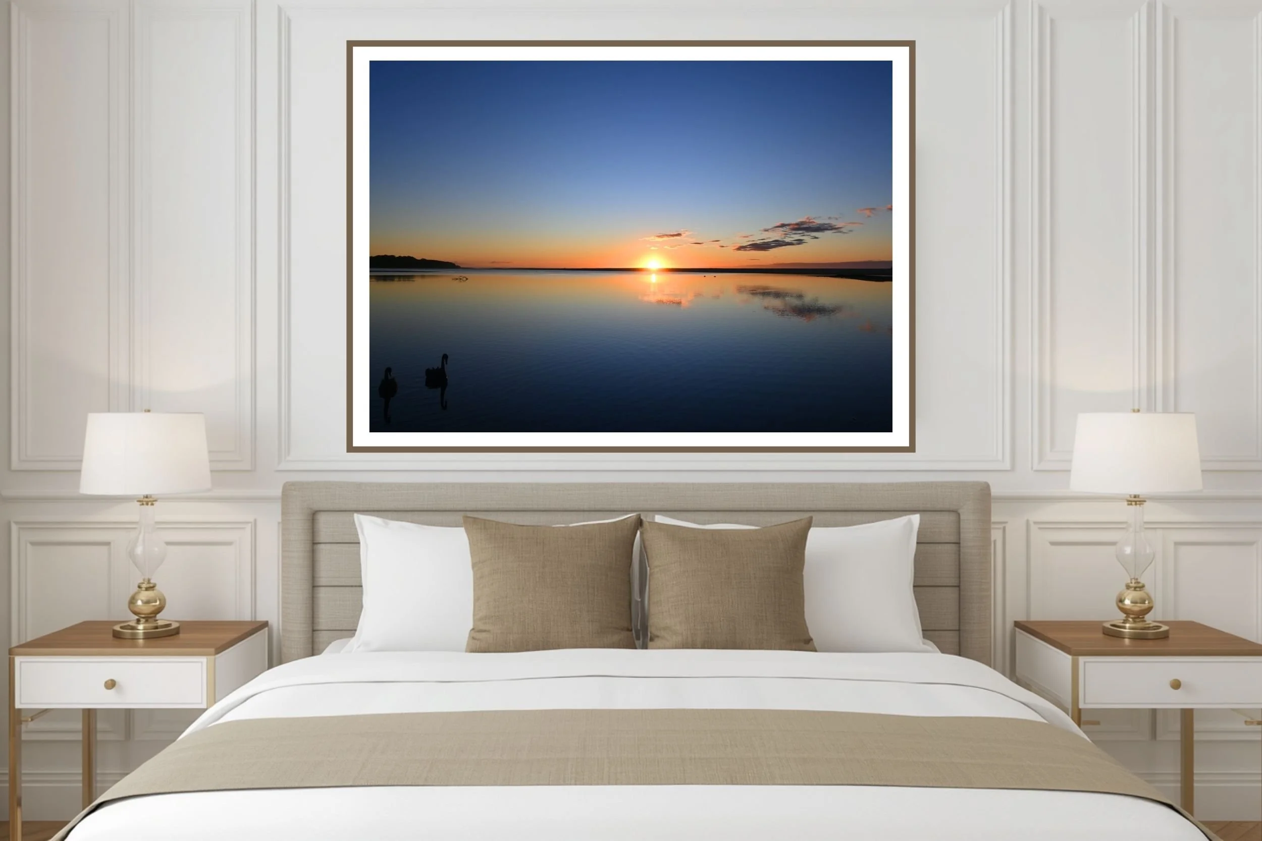 A scenic photograph of two black swans swimming together at sunrise at Lake Tyers Beach Victoria, Australia.