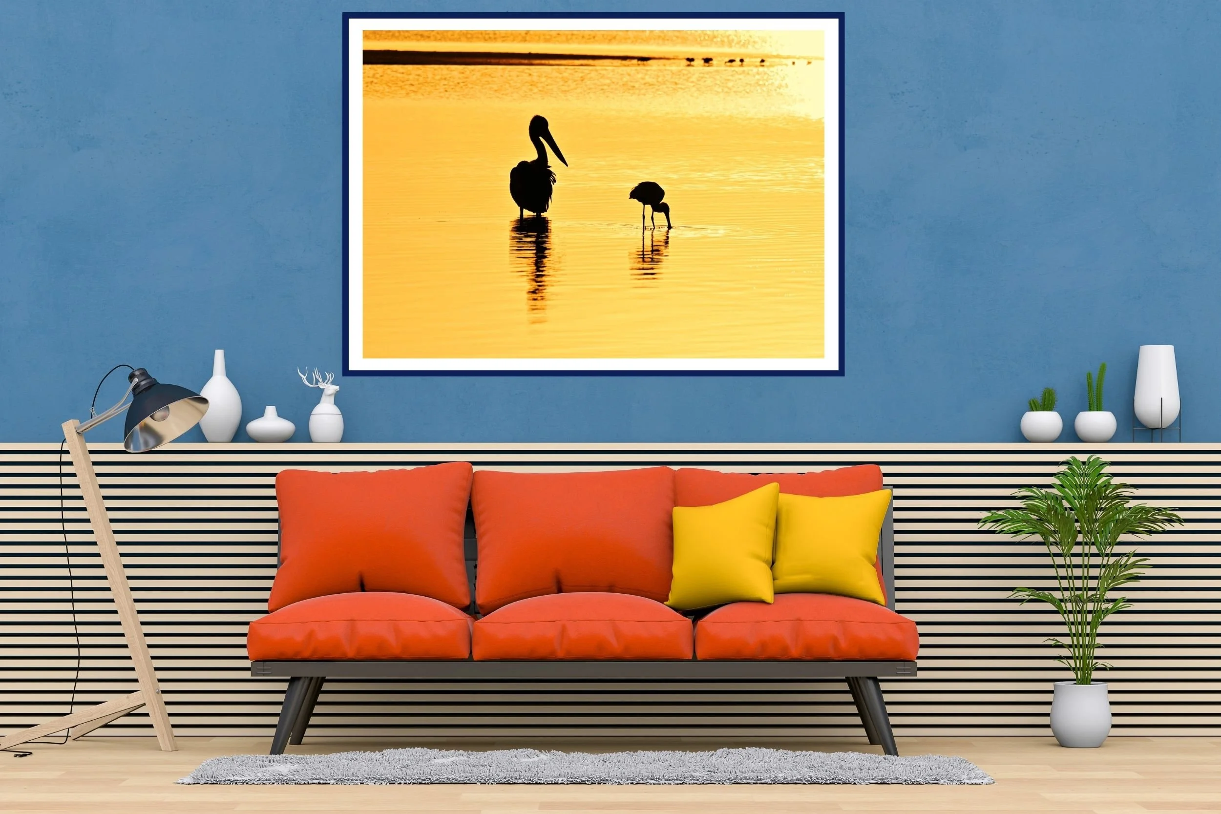 Two Australian native birds (pelican & spoonbill) silhouetted against the lake waters in the morning golden-hour at Lake Tyers, Victoria Australia.