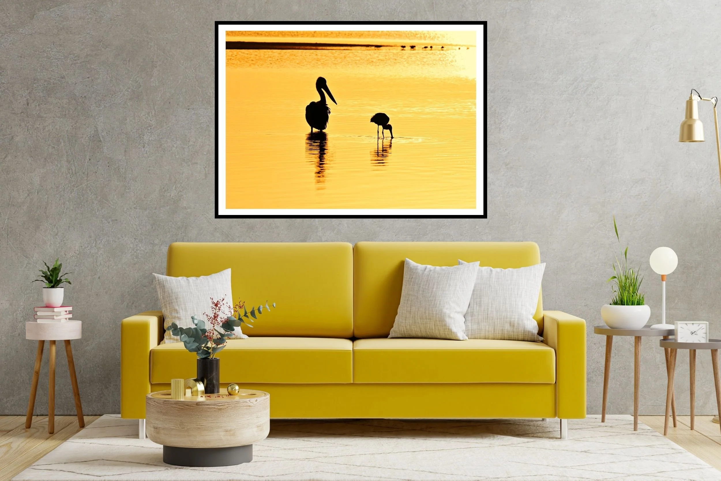 Two Australian native birds (pelican & spoonbill) silhouetted against the lake waters in the morning golden-hour at Lake Tyers, Victoria Australia.