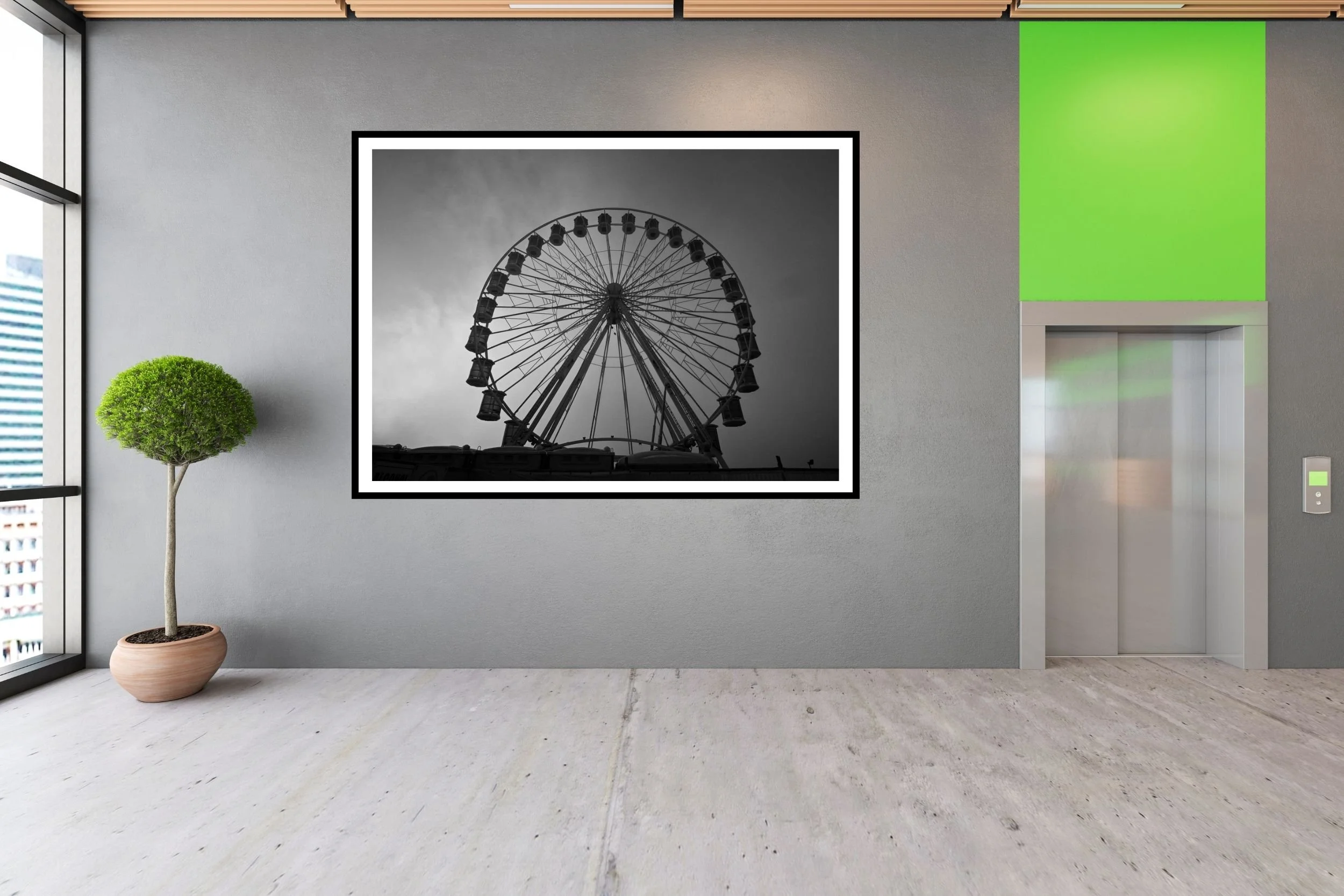 A striking black and white photograph of a carnival ferris wheel set against a foggy and cloudy background
