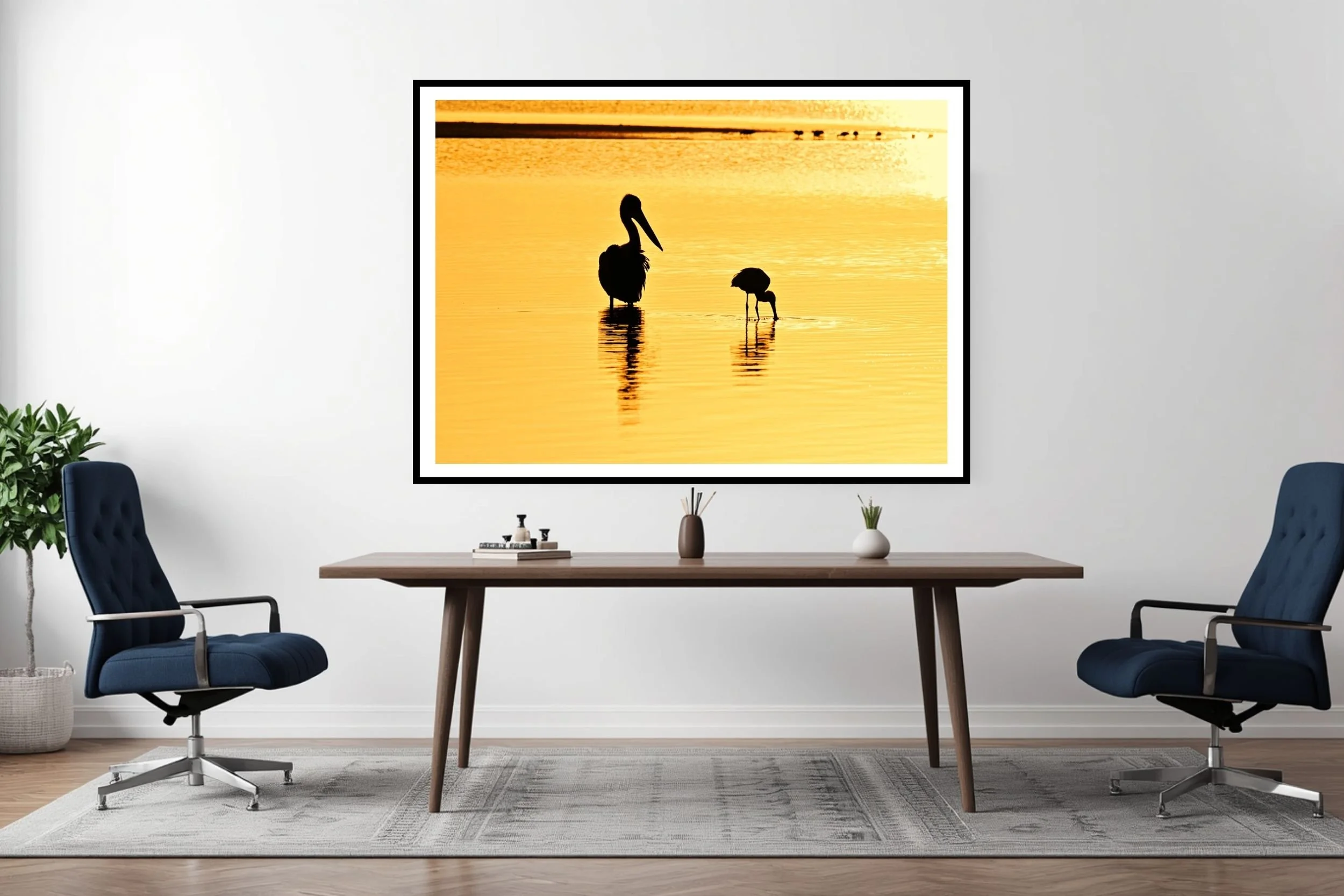 Two Australian native birds (pelican & spoonbill) silhouetted against the lake waters in the morning golden-hour at Lake Tyers, Victoria Australia.