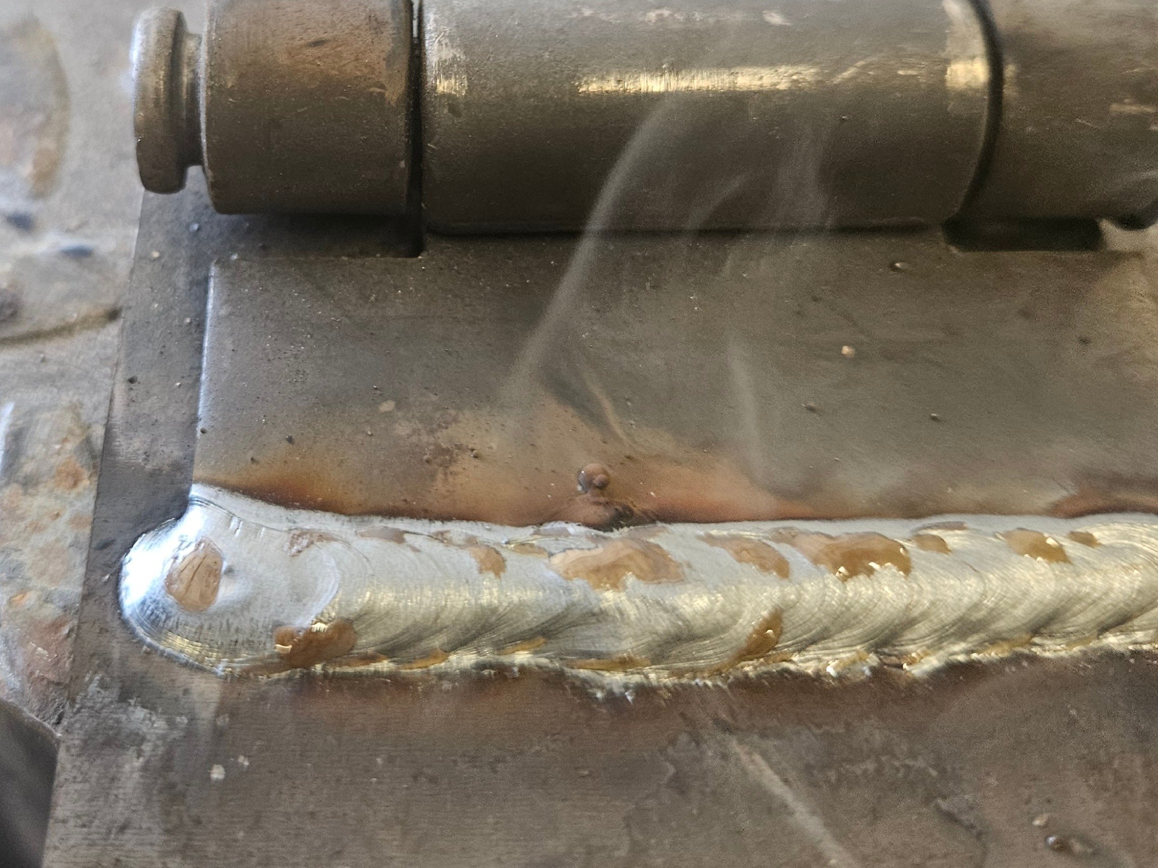 Worn metal shaft repaired by A&J Custom Metals, showing equipment repair and hard facing work in Graham, WA.