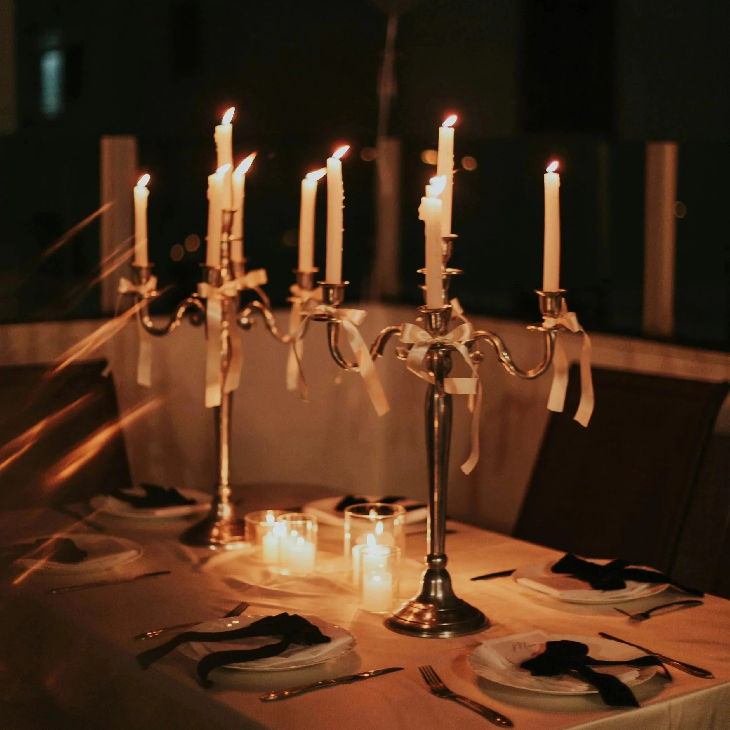 Candle lit dinner. Romantic dinner setting. Wedding tables. Wedding core, silverware, formal dinner.