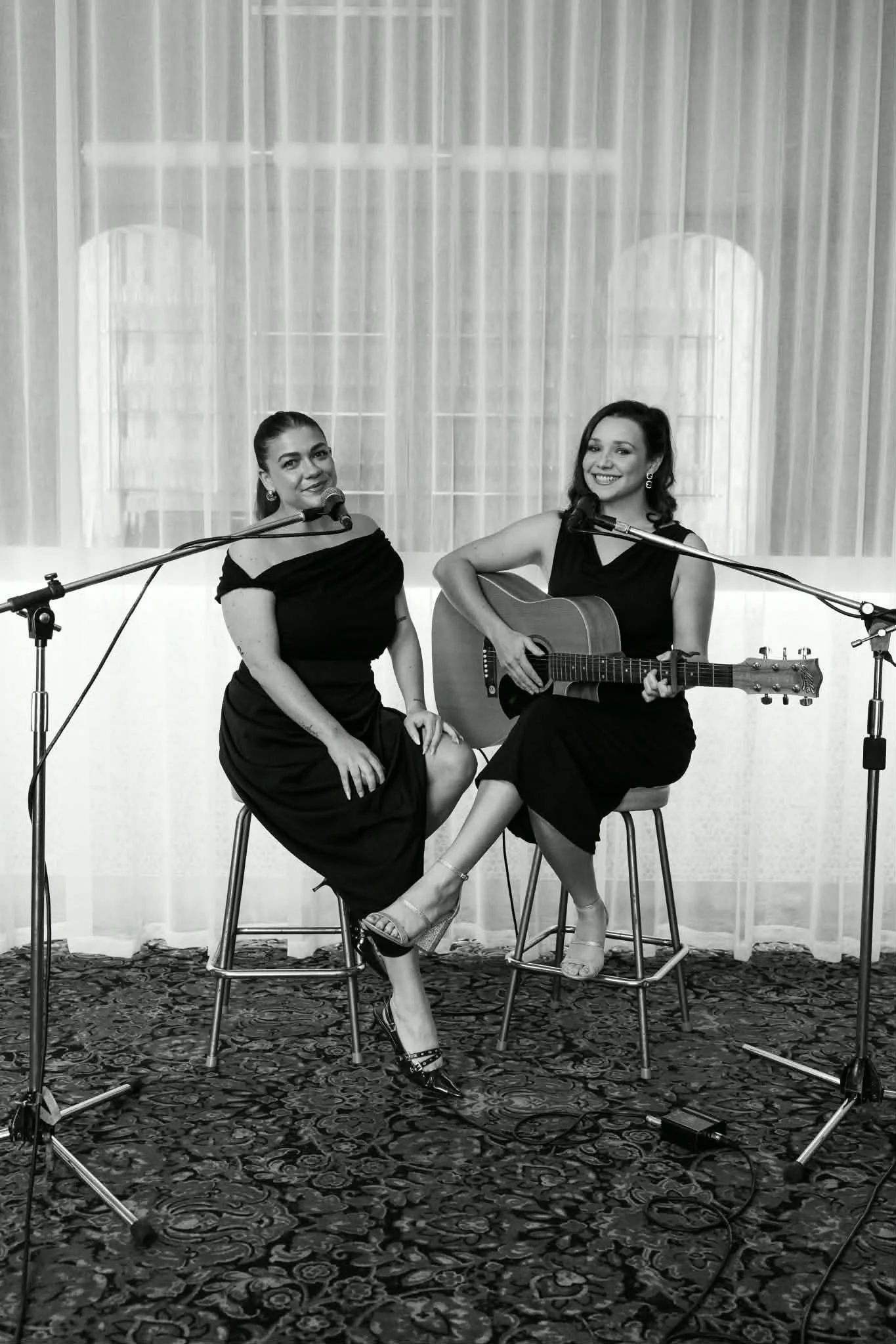 dayna & rosie from acoustic duo 'Azura' music performing live acoustic music. black and white photo with event entertainment.