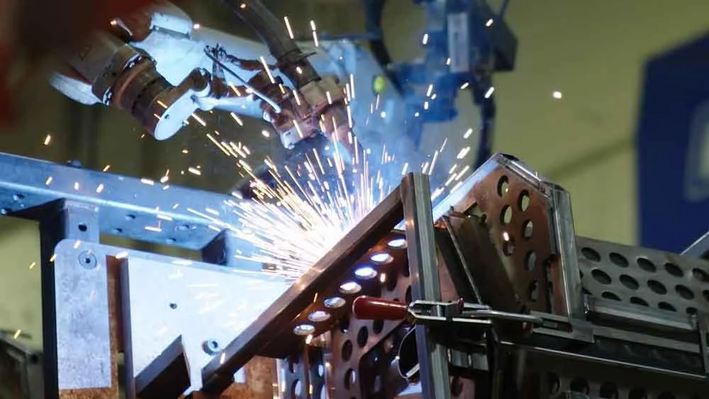 Welder fabricating structural steel in a fabrication shop