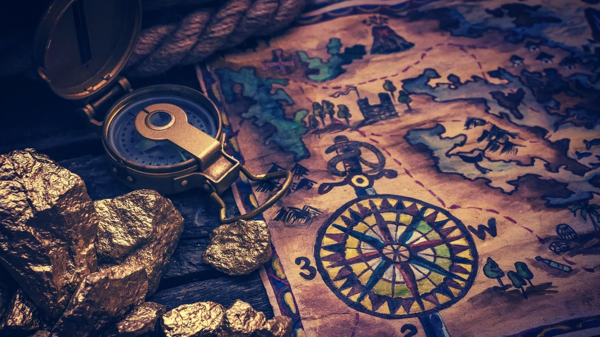 An open compass, some gold nuggets, and a colorful treasure map with drawings of a ship, animals, and a wheel, suggesting a treasure hunt theme.