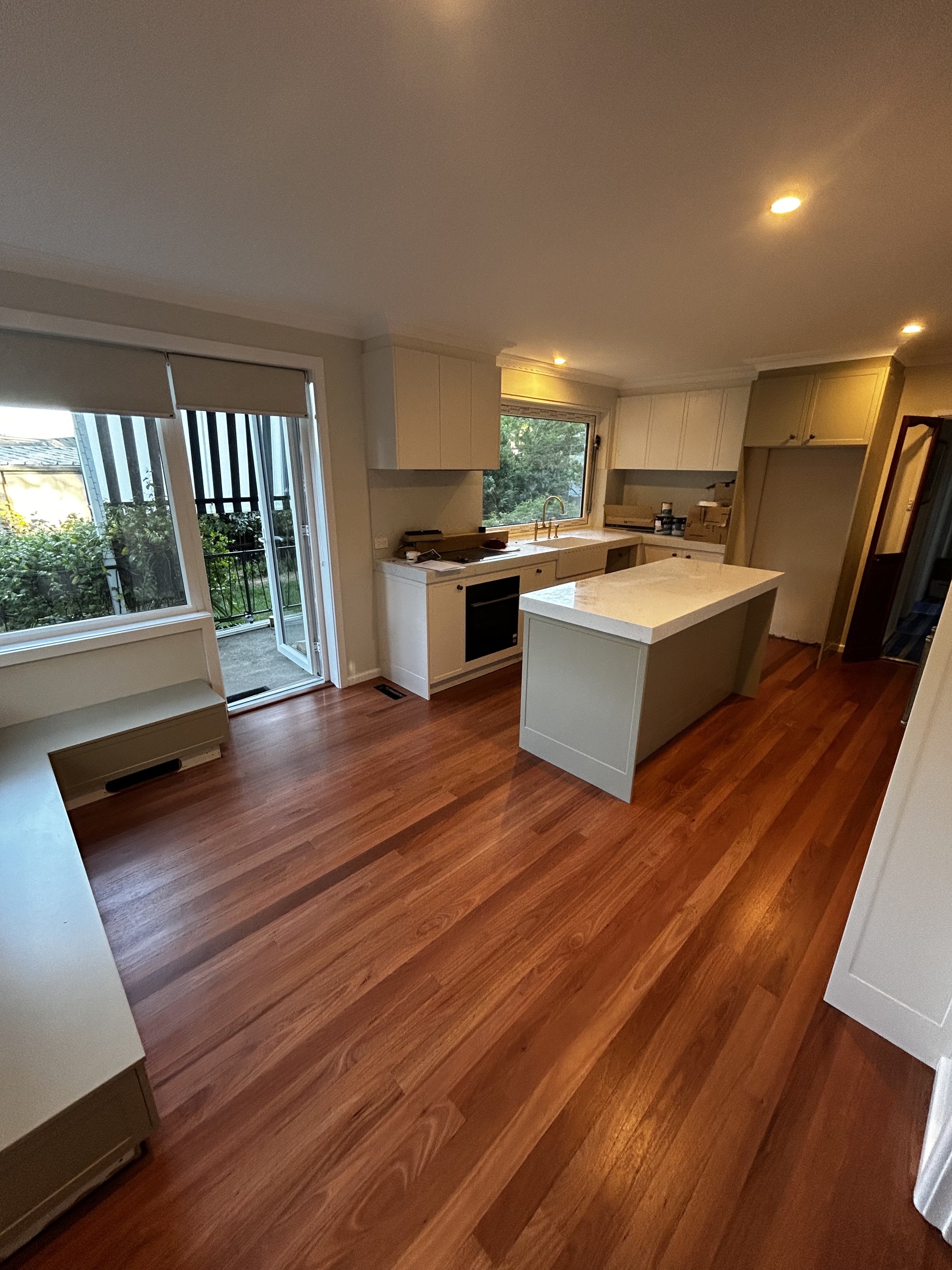 Professional timber floor sanding in Shoalhaven kitchen with outdoor access