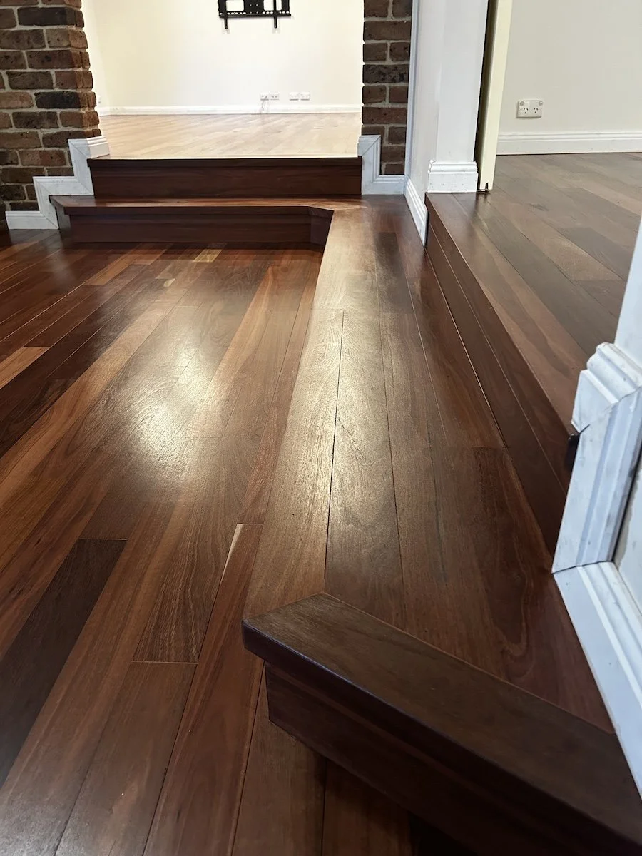 Close-up of polished timber floor transition, hardwood floor sanding Shoalhaven