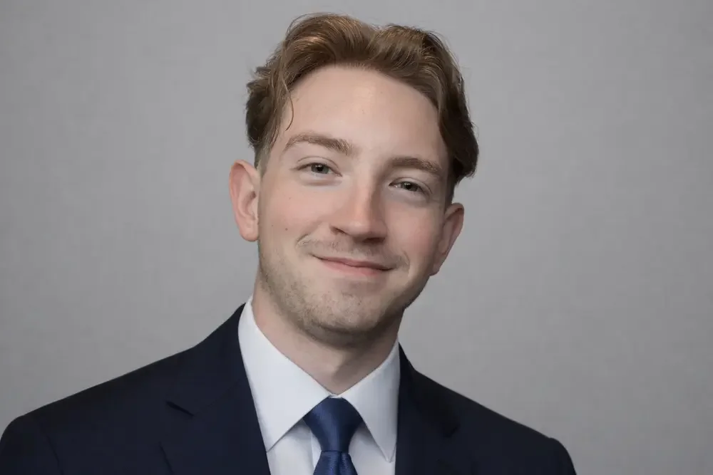 image of the owner of Crystal Clear Window Cleaning in a suit against a grey background