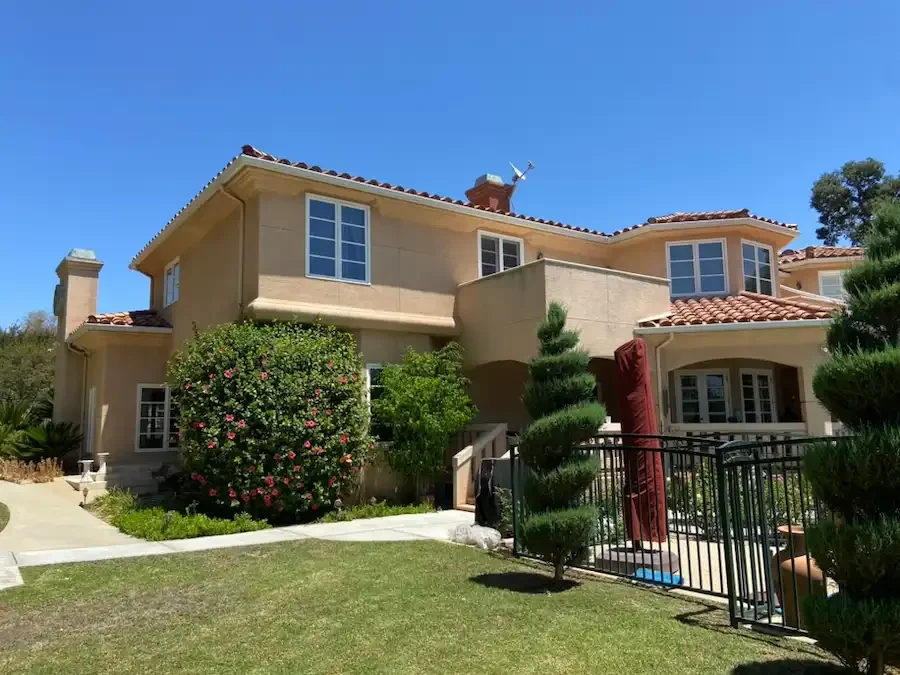 Two-story Spanish-style home with tile roof and arched windows cleaned by Crystal Clear Window Cleaning in the Inland Empire