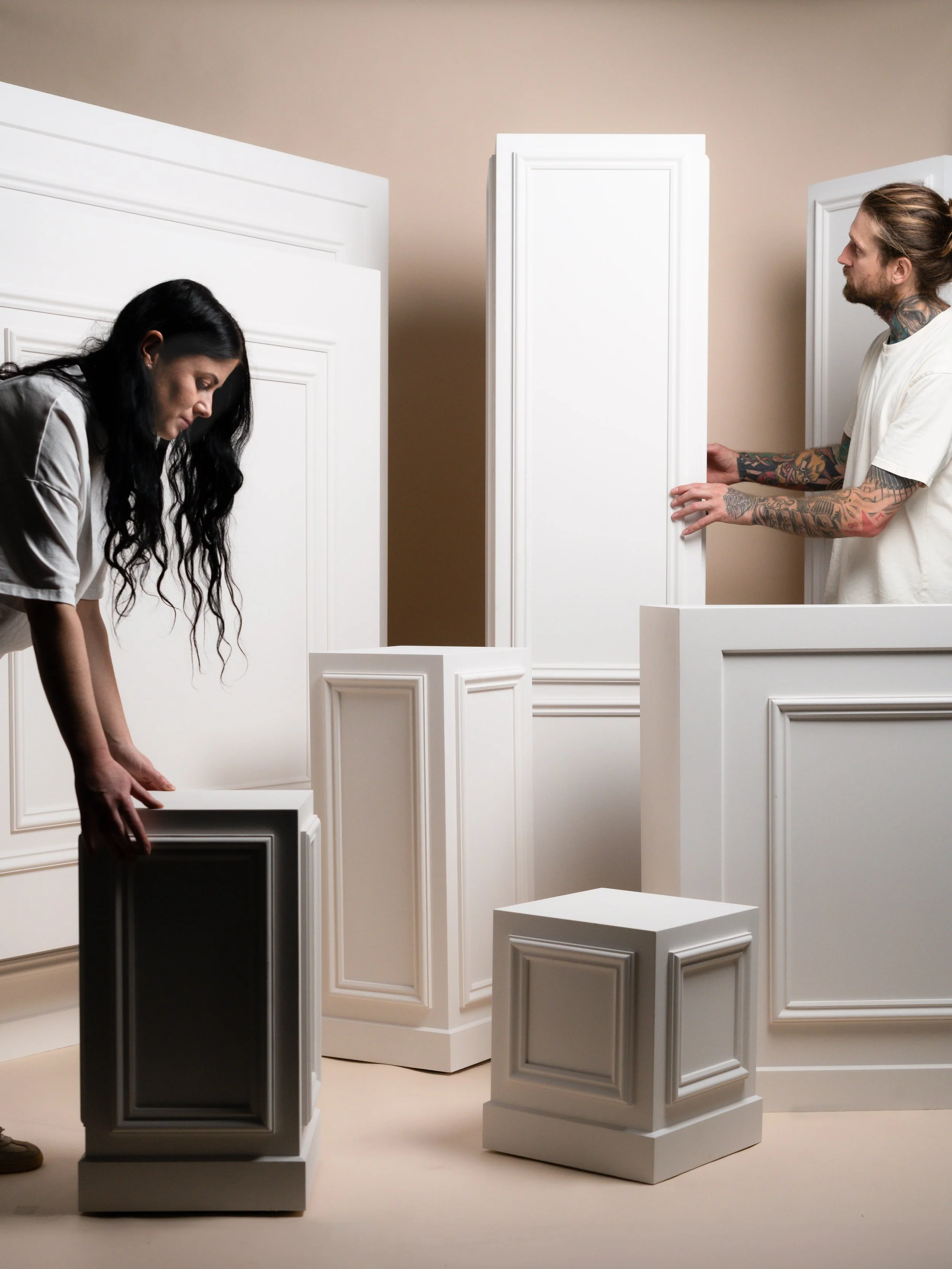 Event Studio owners arranging Classic Collection plinths during a wedding styling photoshoot — modern Taranaki event design