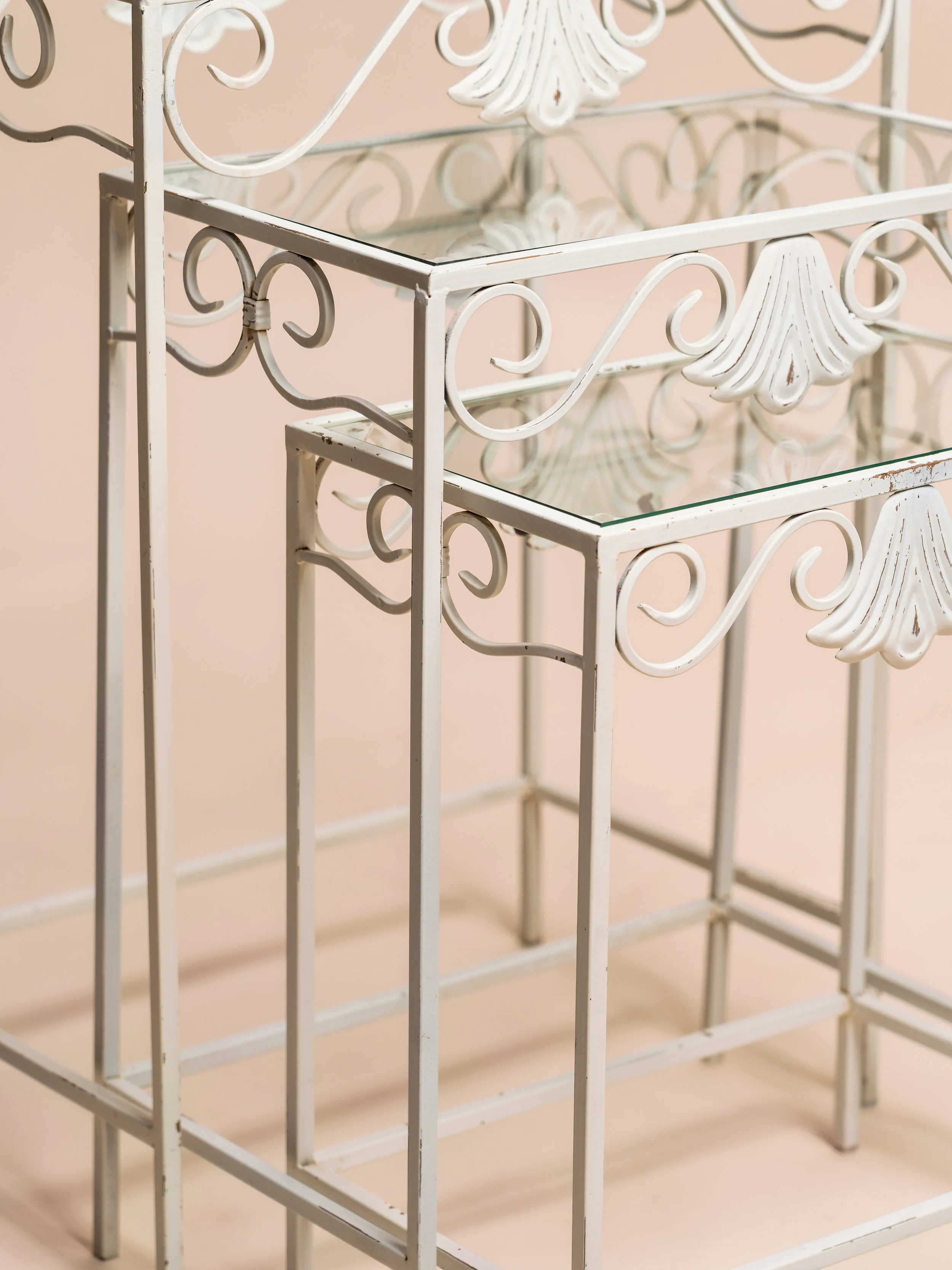 Close‑up detail of the cream vintage nesting tables — event décor hire