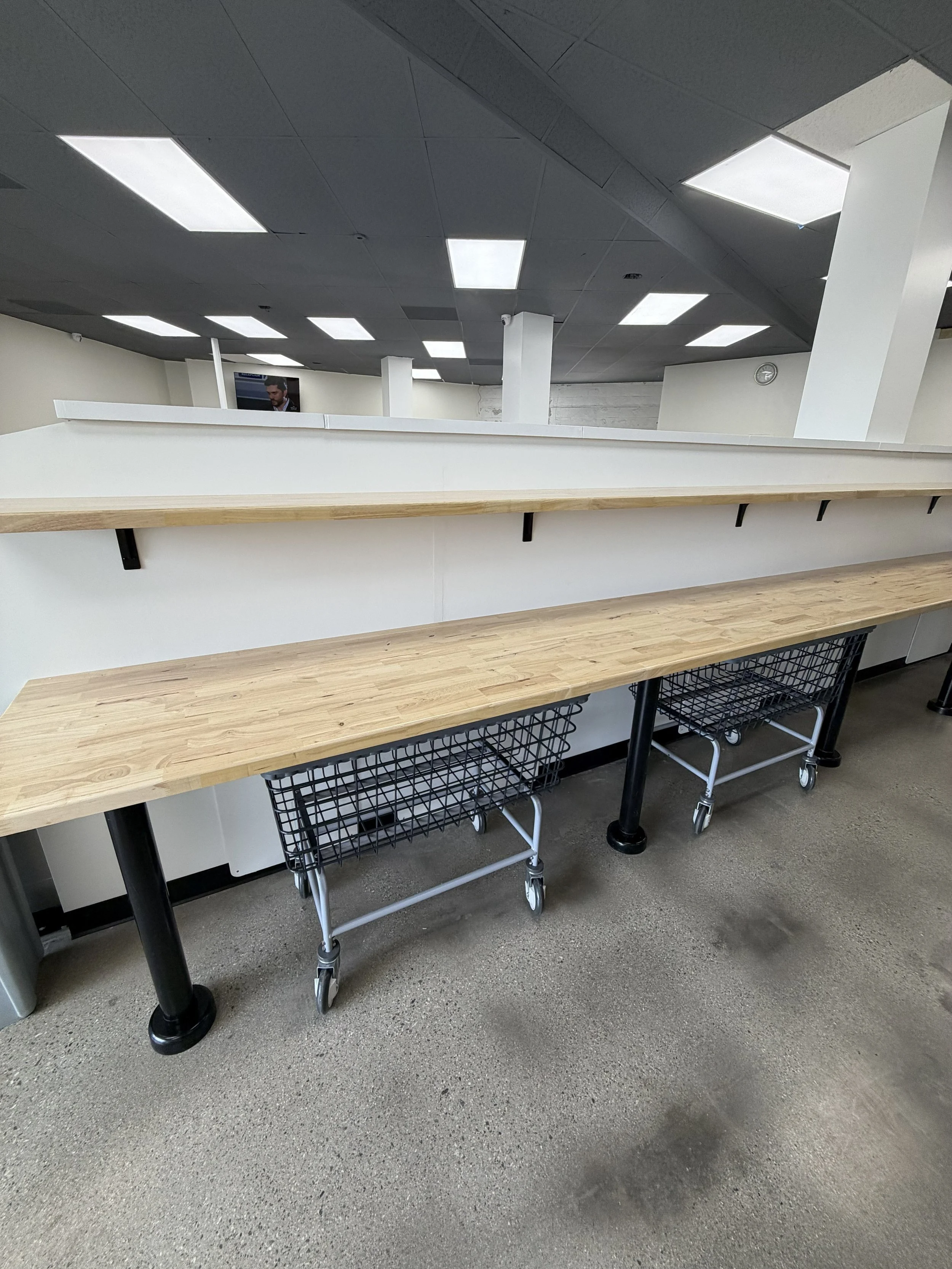 Butcher-block folding counters and laundry carts inside Laundry Room LA