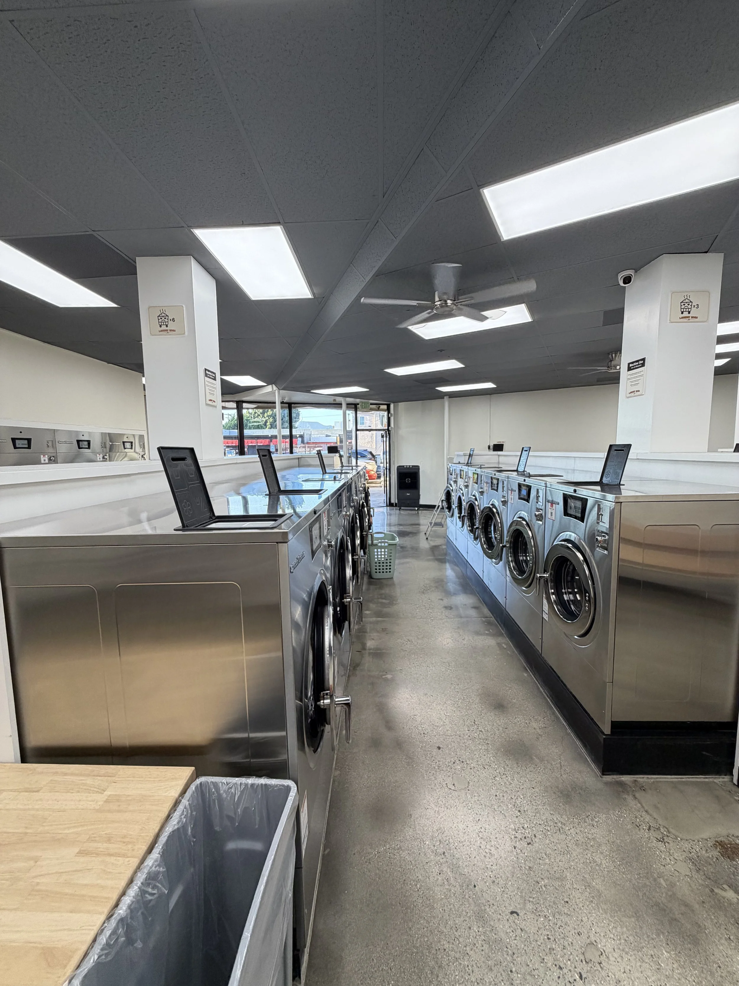 Aisle of Speed Queen washers and dryers inside Laundry Room LA self-service laundromat