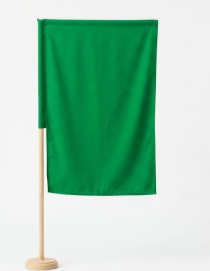 Green fabric flag mounted on a wooden pole