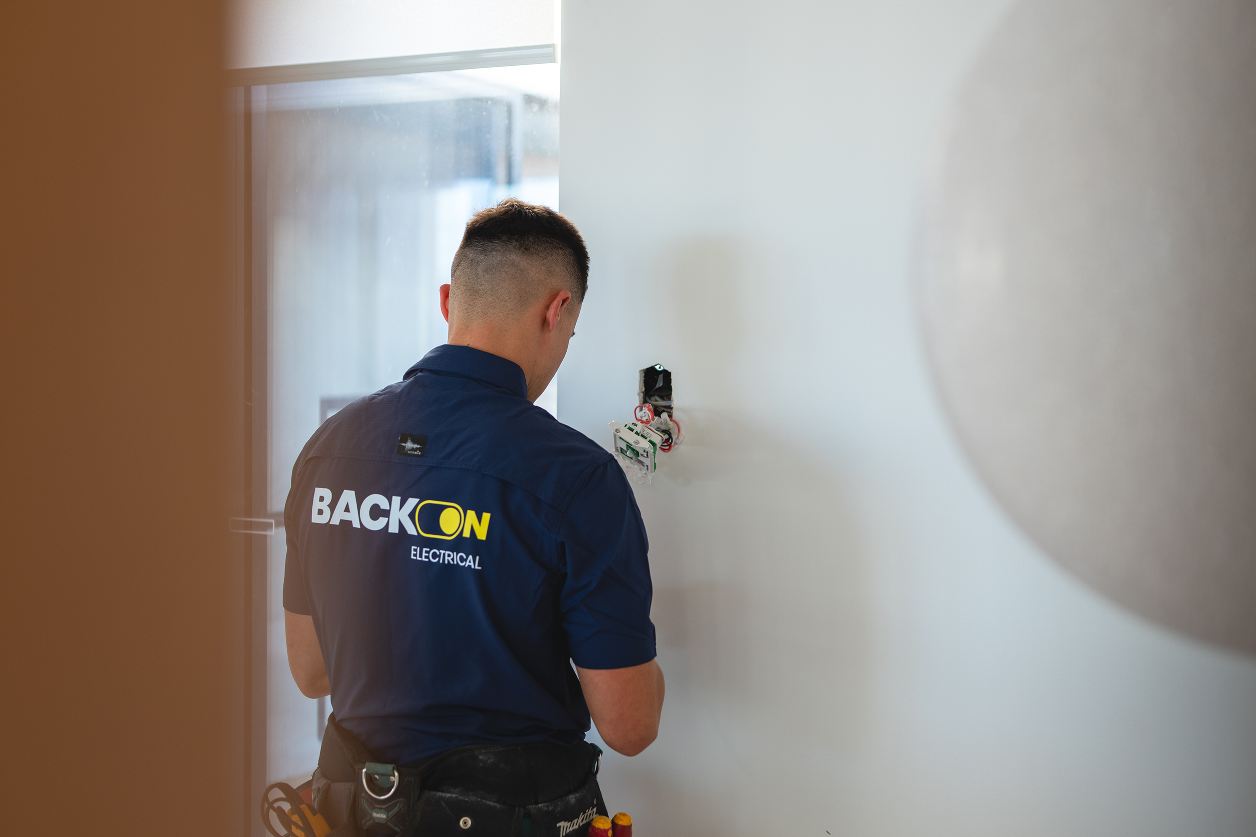 Image of electrician Chris with blue shirt and Back On Electrical logo