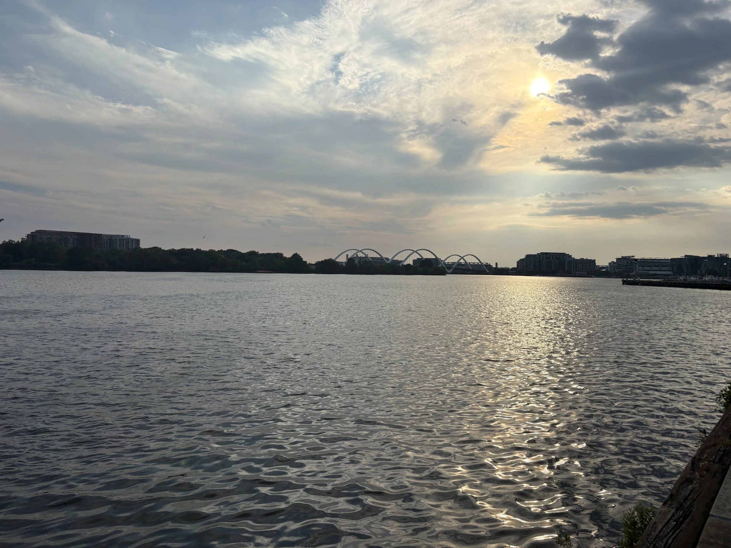 Late-day sun reflecting across the Anacostia River toward the Frederick Douglass Memorial Bridge, photographed by Twan Woods in Washington, D.C., September 1, 2026.