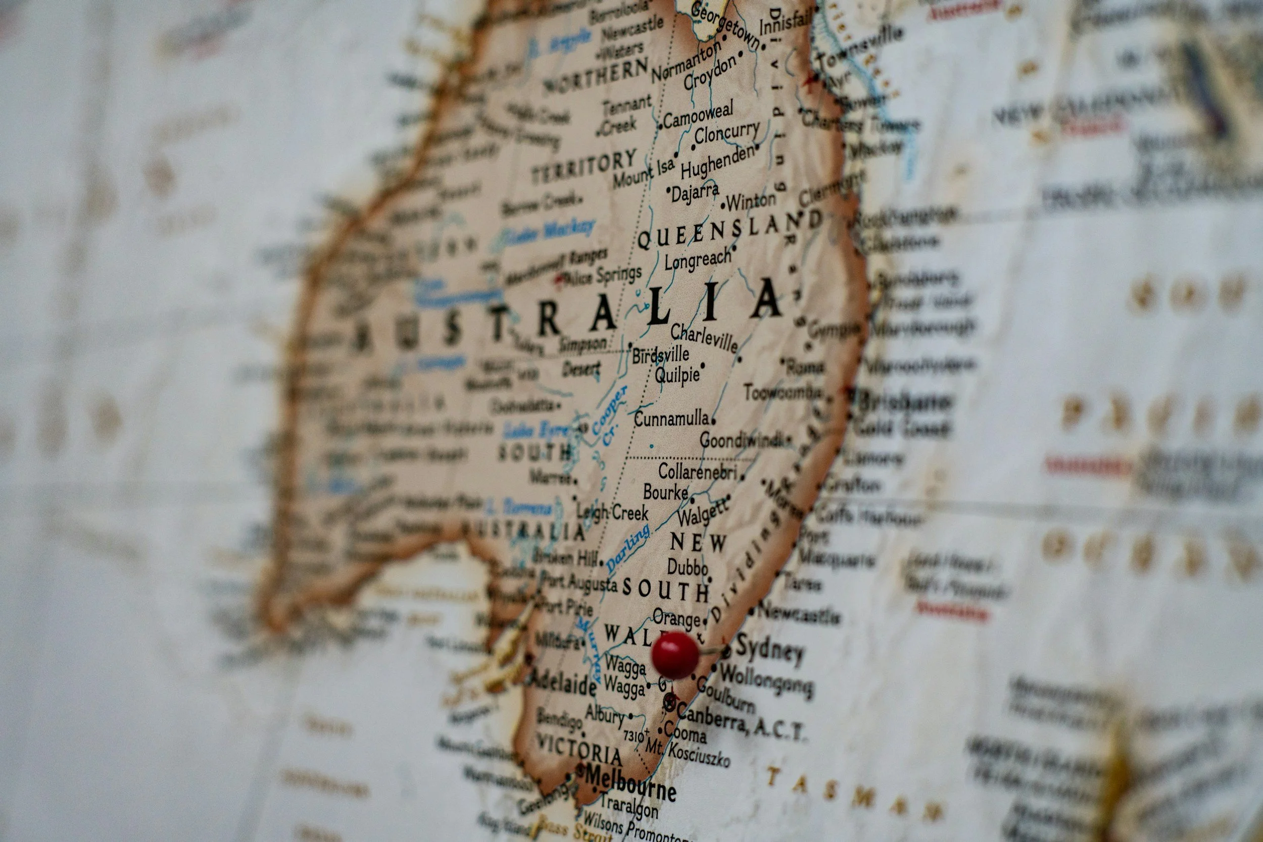 Close-up view of a map showing the country of Australia with a red pin marking a location in the southeastern part of the country.